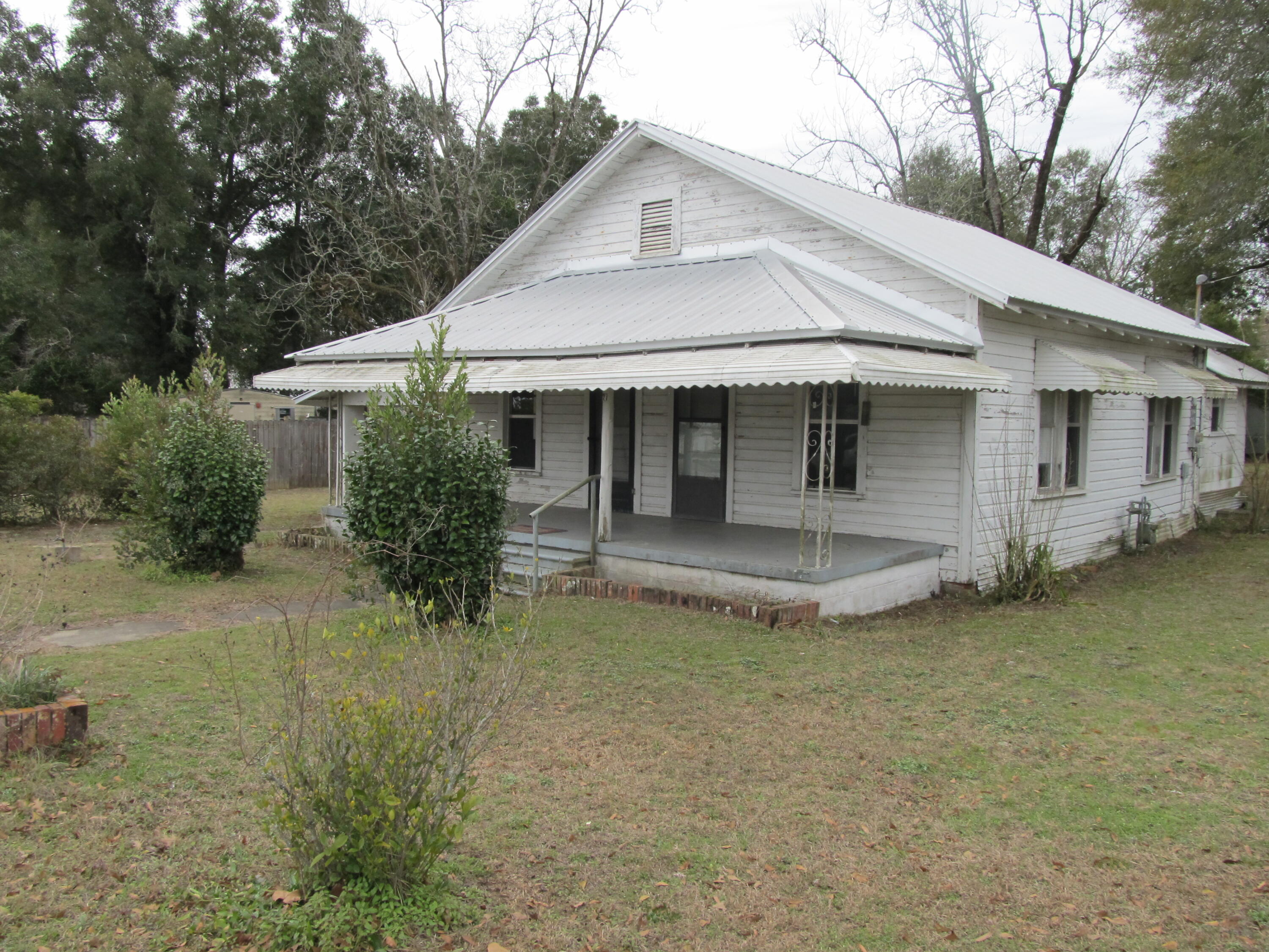 Nestled  in the heart of DeFuniak Springs, this 3 bedroom 1 bath home offers timeless character and endless potential.  Situated on large corner lot, property has plenty of space for outdoor living and creativity.  Inside, you will find generously sized living, dining and kitchen ready for your personal touches. Home also features large utility room at rear of home with convenience, as well as outdoor storage. Whether you're an investor looking to add your unique flare or homeowner eager to transform this gem into your dream space, this property is brimming with possibilities.   With roof and water heater approx. 6 years old, you don't want to miss out on this opportunity to create something special in a prime location.