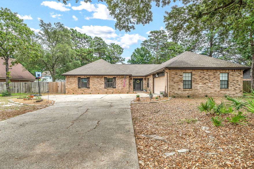 HAMPTON HIDEAWAY. From the outside you'd never guess what awaits you within the walls of this Bluewater Bay property. A well presented entry welcomes you and your guests at home closely followed by an expansive open-plan living area encompassing a large kitchen, dining and living area that provides a bright, open space for everyday family life. The floor of the home is its own center piece that pulls the the interior of the home together and compliments the colors of the walls and kitchen as well. The kitchen is beautifully appointed with such details as white shiplap, subway style tiling, white granite counter tops and stainless steel appliances. Attention is drawn upwards to the timber cathedral style ceiling giving the interior an incredible sense of space and warmth. The master bedroom, complete with walk-in closet and ensuite, ensures parents have a private space away from the children.  This property is situated on a .36 acre lot in the sought after neighborhood of Raintree Estates in the Bluewater Bay area of Niceville.  Residents of Raintree Estates enjoy a private park surrounded by woods with nature trails and a waterfront picnic area with its own boat launch adding yet another unexpected element to a property full of surprises 