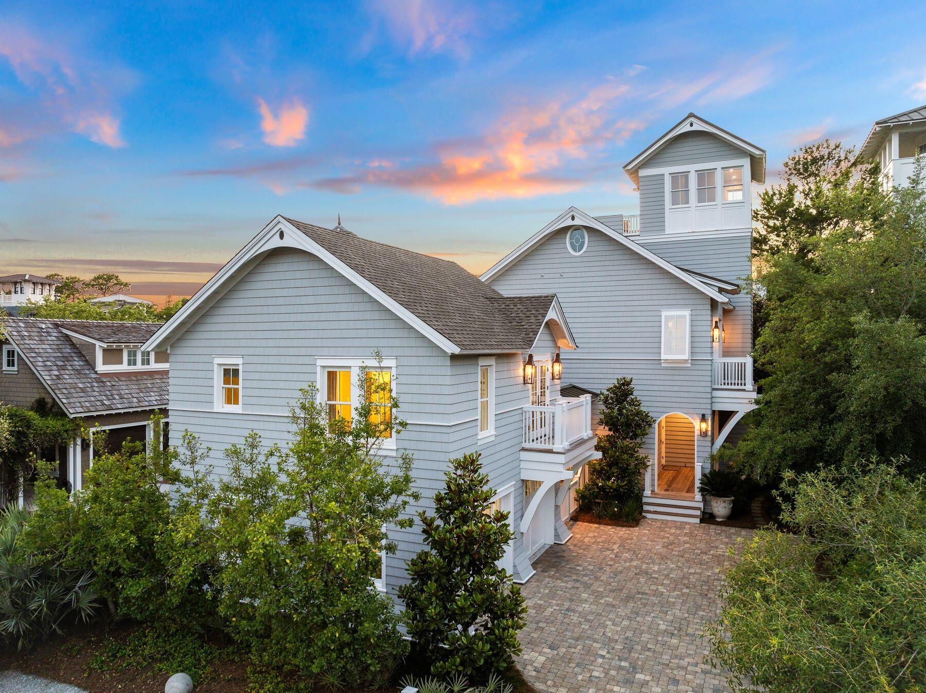 Ideally located in the main section of WaterSound Beach, this finely curated home is close to private beach access and world class amenities. A shaded boardwalk lined with greenery leads to the welcoming front porch. Beautifully designed by Thurber Architecture and built by Dune Construction, this sophisticated home has multiple porches and nooks for relaxing in the peaceful ambiance. The expansive retreat on a quiet cul-de-sac hosts a main house and an independent carriage home atop the spacious 2-car garage, surrounded by lush landscaping for extra privacy. Throughout the home, antique heart pine flooring, vaulted ceilings, large windows and shiplap walls deliver understated elegance. Meticulously cared for, recent updates include designer furnishings, window treatments, new air conditioners, updated electronics, fresh paint, and lush landscaping. Furnishings, golf cart and bicycles all convey to make the transition of ownership a.breeze.

The reverse floor plan is designed for social gatherings and family celebrations with an open great room on the second floor featuring a fireplace, vaulted ceilings and multiple windows. Twin sets of French doors off the great room provide fresh breezes and extended living space. Chefs will be drawn to the kitchen, which features custom cabinets, a charming farmhouse sink, and an expansive marble breakfast bar. Also on the second level, the primary suite boasts lofty vaulted ceilings, a private balcony and two walk-in closets. The exquisite ensuite has a deep soaking tub, dual vanities and a tiled walk-in shower. Two stunning guest bedrooms with ensuite bathrooms occupy the first floor along with a first floor living room with custom bunk area to sleep four for the ultimate slumber party. The home's large laundry room is on the first level with a separate door near the outdoor shower to make returning from a day at the beach easy. The open-air tower offers breathtaking views across the community with occasional glimpses of the emerald Gulf of Mexico. A large driveway provides access to the two-car garage with an outdoor staircase leading to the one-bedroom carriage house above. The carriage house, providing another bedroom, living space and kitchenette is perfect for independent family members and guests, or for rental income. This refined home is conveniently located to access the fitness center, private beach, WaterSound Beach Club and miles of nature-filled boardwalks. Nearby attractions include boutiques, restaurants and entertainment at Rosemary Beach. Outdoor recreation is offered at Camp Creek Lake and various state parks nearby.
