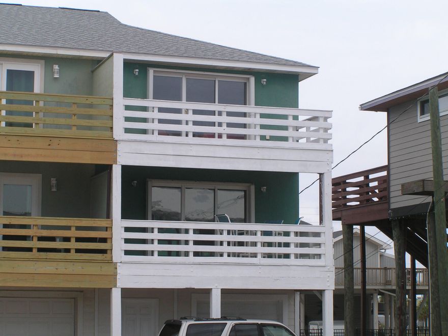 Navarre Beach gulf view townhome located directly across the street from the Gulf of Mexico with beautiful unobstructed water views.  This exceptional furnished townhouse with large covered deck is ready for you to enjoy or to rent out.  One-car garage, two outside parking spaces, and large storage room on ground floor.  Great room, kitchen, 1/2 bath, and washing room on second floor.  Two bedrooms with private baths on third floor.  Great second home or excellent vacation rental.  No HOA dues.  New roof in November 2020.
