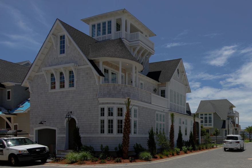Designed by well-known architect Rick Lowe, this 4 bedroom, 5-1/2 bath home offers grand living in the magnificent setting of Grace Point on 30A. Boasting a balanced blend of coastal chic, wood tones, the layout, and flow of the home is both welcoming and timeless for friends and family to enjoy. Upon entry to the residence, the overhead hand-hewn beams will captivate your attention, as you step onto the warm hardwood flooring, your eye is drawn to the shiplap & tile clad fireplace creating a dramatic and cozy statement.The gracious great room offers seating for family gatherings and entertaining and the outdoor living becomes seamless with large doors opening to the wide screened-in porch. Surrounding the large center island, Subzero and Wolf appliance packages offer the perfect