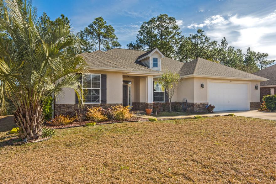 BEAT THE TRAFFIC and start enjoying your SOUTH CRESTVIEW retreat sooner! Situated on a private, wooded lot in a charming, single street subdivision SOUTH of I-10, this high quality home will exceed your expectations! Built by the well-respected local builder Key Lime Construction in 2011, this 4 bedroom, 2 1/2 bath property features a split bedroom plan and open concept living/kitchen/dining layout. Delight in uncommon, thoughtful details like tile-surround and mantle for the fireplace, granite counters in the kitchen, laundry room, and both full bathrooms, judges paneling in the formal dining room, and a fully screened back porch accessed via double glass-paneled doors off the living room. Zoned for desirable Antioch Elementary School, short drive to 7th Group, Eglin, and the beaches!