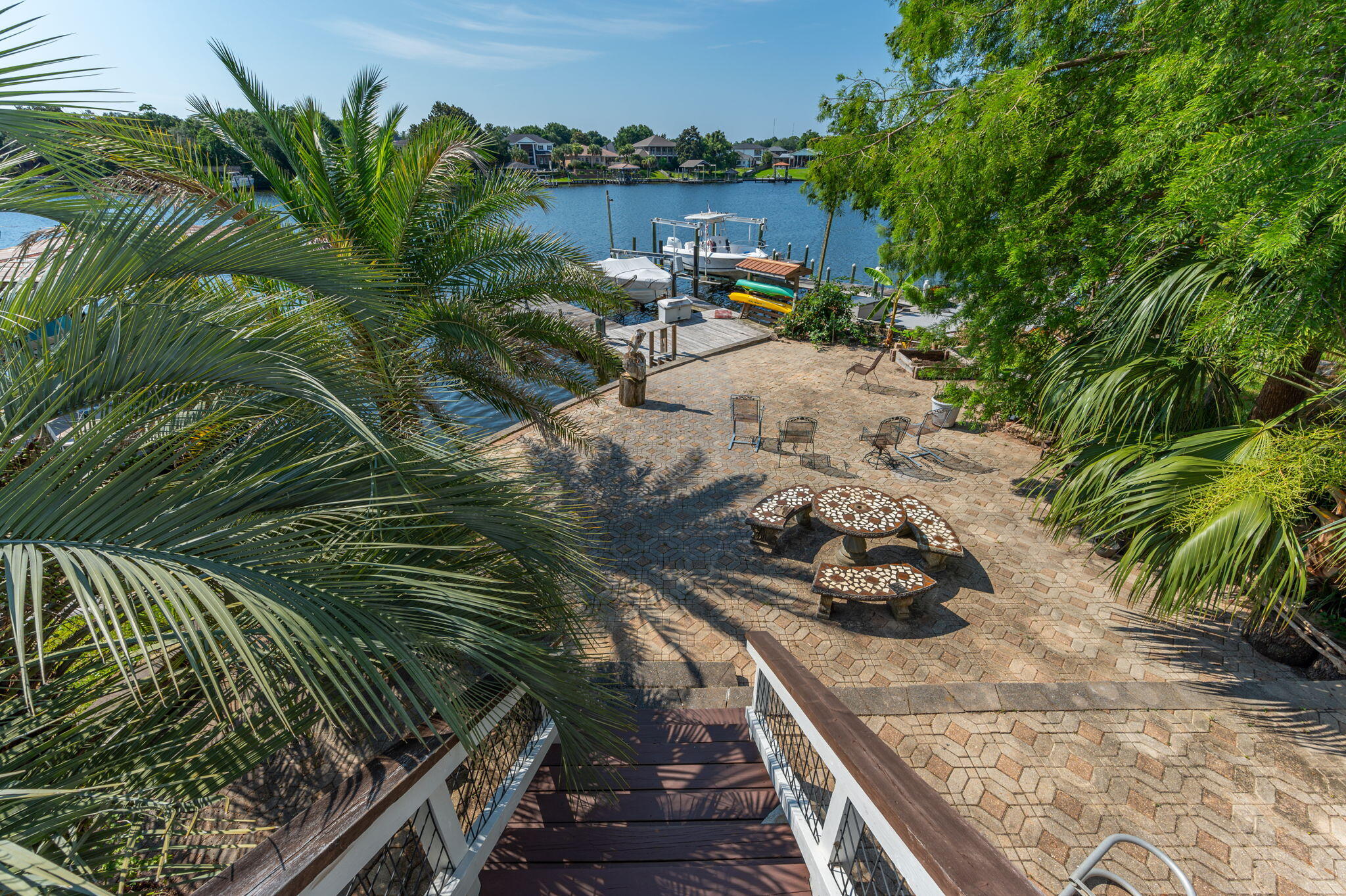 Step into your own piece of paradise with this stunning brick home nestled along the deep waterfront of Cinco Bayou. Whether you're seeking a permanent haven or a luxurious summer escape, this property is the answer to your dreams. As you walk through the doors, you'll be greeted by vaulted ceilings and elegant tile floors, setting the stage for the ample space within. The kitchen is a chef's delight, featuring stainless steel appliances, a sub-zero fridge, a Wolf gas range, granite countertops, and a spacious island. Each room in this home is equally impressive, with the master bathroom boasting a double vanity sink, a luxurious garden tub, a separate shower, and a generous walk-in closet. But the true gem of this property lies outside... where an outdoor kitchen and abundant shady spots await, providing the perfect setting for hosting summer get-togethers. And when you're ready to unwind, the dock offers the ideal spot for a boat ride or simply relaxing by the water. Welcome to your new oasis.
1-year-old roof, transferable flood policy, high and dry home out of the flood area! Seller never saw a storm surge over the seawall. Whole house gas generator, under porch storage area. Welcome to your new oasis.