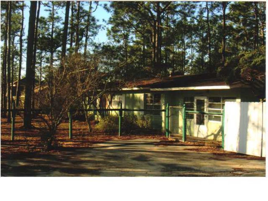 This large block home is situated on the corner of Bourbon Street and HWY 331. The 3 bedroom home fronts on HWY 331 and is on one lot, giving someone the ability to use the other 3 lots for building or use them for a large fenced yard. The home will need some updating and is sold ''AS IS.'' This is a prime parcel with 4 lots fronting on HWY 331 and the entrance to Cross Creek Estates. A new paved and lighted road has just been completed and a turnlane was put into the road. Great large parcel with many possibilities.