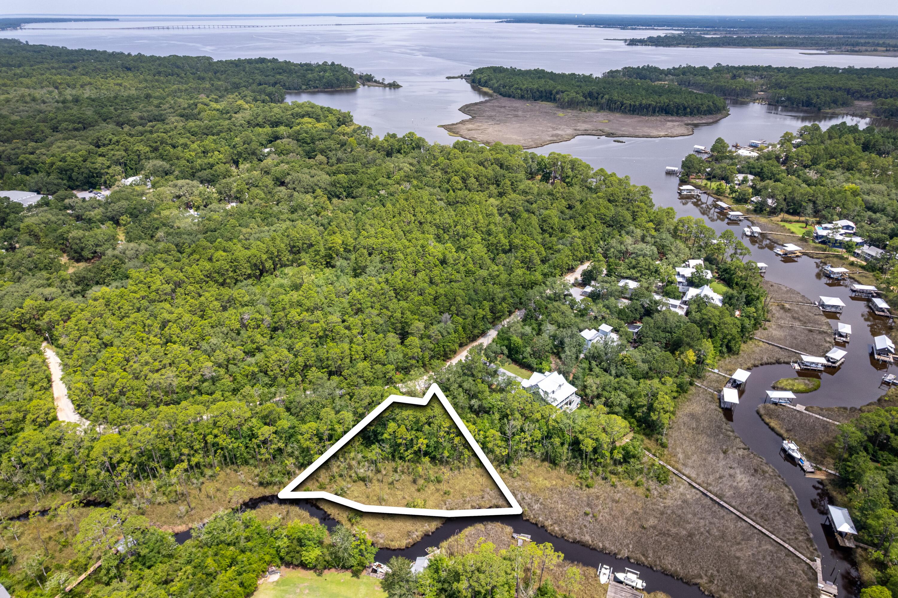 Build your dream home on this rare canal-front lot tucked away in the charming and highly sought-after community of Point Washington, just minutes from the beaches, shops, and 30A dining. This spacious homesite offers direct canal access leading to the Choctawhatchee Bay--ideal for boating, paddleboarding, kayaking, and enjoying all the coastal lifestyle has to offer. With mature trees providing natural privacy, and a quiet, no-HOA neighborhood, this is the perfect blend of serenity and convenience.Whether you're planning a primary residence, second home, or investment build, this property checks every box!