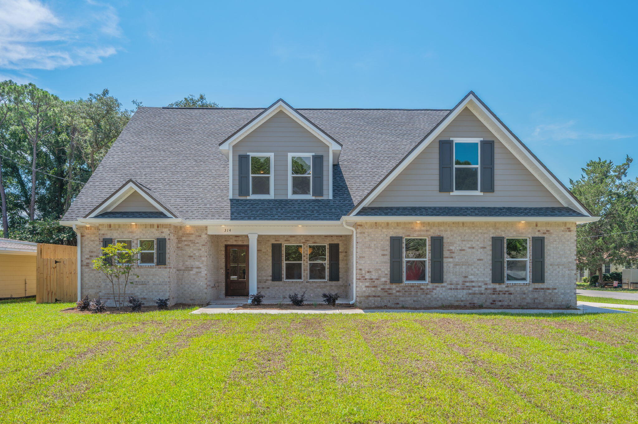 This beauty is located in the highly desirable Elliott Point neighborhood of Downtown Fort Walton Beach, this brand new 2025 home by Grand American Homes offers over 3,060 square feet of thoughtfully designed living space with 6 bedrooms, 3 bathrooms, and upscale finishes throughout. This two-story home offers a main floor master bedroom and 2nd bedroom with a full bathroom, a formal dining room and breakfast nook. The designer-like kitchen offers soft close cabinets, a built in pantry, quartz countertops and a tiled backsplash.The true star of the show is the gas fireplace that will be the centerpiece of your living space, with marble tile, a cypress mantel and shiplap detail it makes a perfect gathering place for all occasions. On the 2nd floor you will find a loft space perfect for a small home office and 4 additional large bedrooms! This home also includes 2 laundry rooms! No more lugging clothes up and down the stairs!
Some additional features of this home include LVP/Tile flooring throughout, Crown molding, solid pine baseboards, gas package to include gas furnace, range, dryer, fireplace, grill stub out and tankless water heater.
Located within walking, biking, or golf cart distance to local shops, restaurants, pickleball courts, the yacht club, public boat launch, and neighborhood water access, this home places you in the heart of Fort Walton Beach living. With the beach just under 2 miles away, and Eglin AFB and Hurlburt Field both less than 5 miles, the location couldn't be more ideal.
Don't miss this opportunity to secure your place in one of Fort Walton Beach's most sought-after neighborhoods. Contact us today to learn more about the amazing builder incentives and make this home yours!