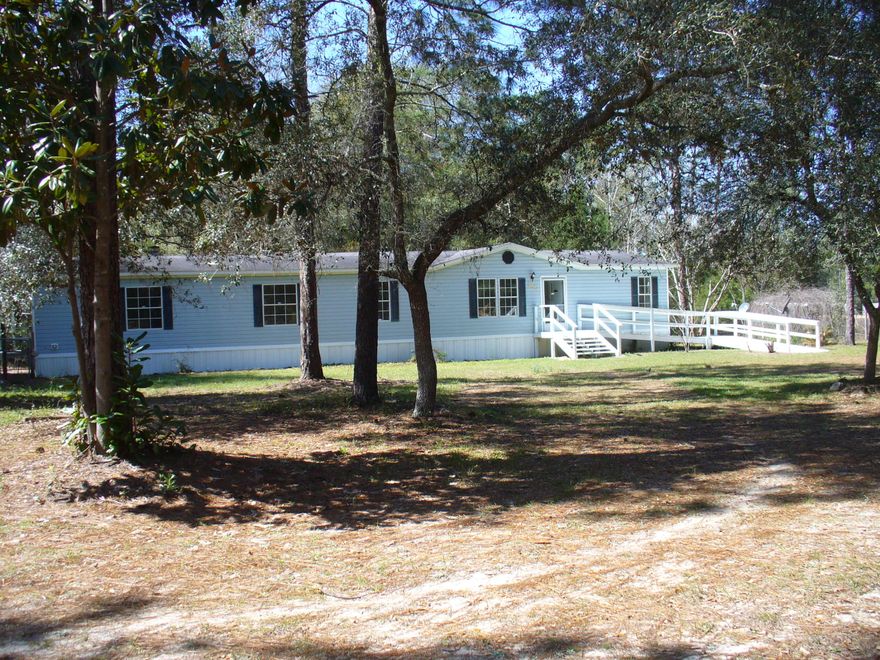 HORSES WELCOME--5 acre partially wooded & secluded farmette. UPDATED & spacious 2100 sq. ft. home has 4 bedrooms and 2 full baths. It features a living room, dining area & great room with wood burning fireplace. New features & Upgrades include: laminate flooring, re-finished kitchen cabinets, light fixtures, fans, interior doors, sliding glass door, kitchen appliances -stove, refrigerator, dishwasher, new 5 ton AC, 2 ramped entrances.A 4 Stall barn & tack room with gate access from 2 roads. Perimeter & cross fencing. Private well w/water lines throughout the property. Enjoy horses, dirt bikes and 4 wheel adventures.Hugh insulated workshop with dedicated service panel plus a storage shed. Lots of land and storage for your family, animal or equipment needs. Property sold AS IS.
