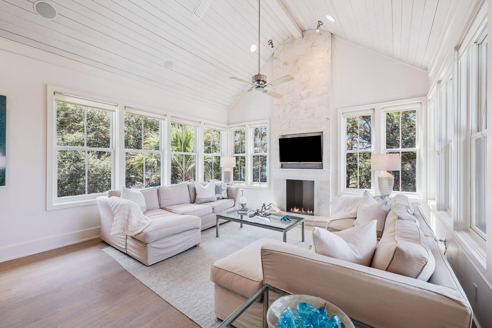 Welcome to a coastal modern masterpiece where the serene beauty of the beach meets sophisticated design. This one-of-a-kind Richard Fouquet and Dawn Thurber collaborative creation is nestled in the exclusive Peninsula section of WaterSound Beach, boasting only 35 home sites for ultimate privacy. Step inside to an open-concept layout featuring gracefully elevated ceilings and a stunning living room with vaulted accents highlighted by a cozy gas fireplace. With hardwood flooring, a state-of-the-art Sonos system, and interiors inspired by the tranquil hues of nature, every detail invites the outdoors in for an unparalleled living experience. The gourmet kitchen dazzles with top-tier Viking appliances, exquisite St. Charles cabinets, and a dramatic 10-ft island that serves as the heart of culinary adventure. Striking Murano glass pendant lights add an artisanal touch overhead, perfect for both cooking and entertaining. This innovative reverse floor plan offers the unique option of an upstairs or first-floor primaries both offering king suites featuring dual vanities. The upstairs primary suite further impresses with vaulted ceilings, creating a serene retreat for rest and relaxation. Every bedroom in this residence is designed for ultimate comfort, with all four bedrooms boasting their own ensuite bathrooms. Outside, enjoy 1,400 square feet of expansive covered porches that seamlessly blend indoor and outdoor living, an exterior shower perfect for rinsing off after a day at the beach, and an outdoor shed ideal for storing bikes and gear. There's even room for a garage and a pool to complete this exceptional property. Experience coastal living redefined where the beauty of the beach becomes an integral part of your home.