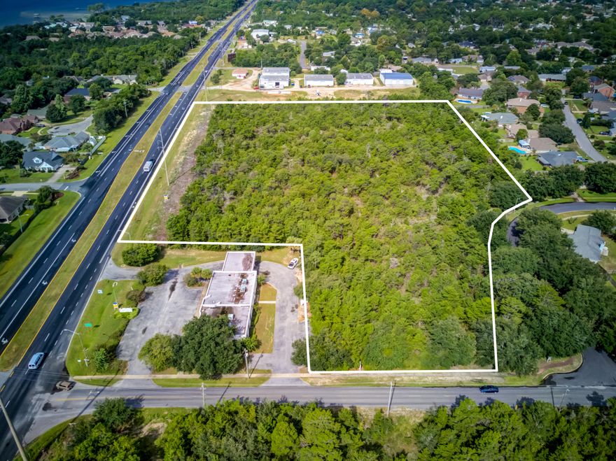 Prime development acreage yielding+/-9.5 acres and over 650' along Highway 98 in Santa Rosa County, Florida! The adjacent corner parcel, which contains a vacant bank building measuring approximately 4,438 SF, is available as well, listed separately under MLS 805027. Zoning is as follows: (HCD) Highway Commercial Development District.Buyer must very all information and specifications.