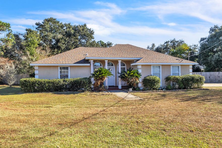 Light-filled and welcoming, this well-maintained home sits on an oversized 0.7acre corner lot in the highly sought-after Holley-by-the-Sea community. The main living area offers raised ceilings, great natural light, and an easy flow into the dining space and updated kitchen. Recent upgrades include brand-new granite countertops (2025), updated stainless steel appliances (2025), and a warm stone backsplash. The spacious primary suite features a walk-in closet, access to the screened porch, and an en-suite bath with dual vanities, garden tub, separate shower, and new faucets (2025). Two additional bedrooms also offer walk-in closets and flexible space for family, guests, or work-from-home needs. Enjoy outdoor living with a large deck, fenced yard, and room to personalize the generous lot. Major improvements include: 2024 Lennox HVAC, 2022 roof, 2022 secondary electric panel, 2021 water heater, and updated fencing/decking. Holley-by-the-Sea amenities include multiple pools, a full fitness center, tennis courts, sauna/steam rooms, clubhouse, boat launch, playgrounds, and more. A great opportunity in one of Navarre's most desirable communities.