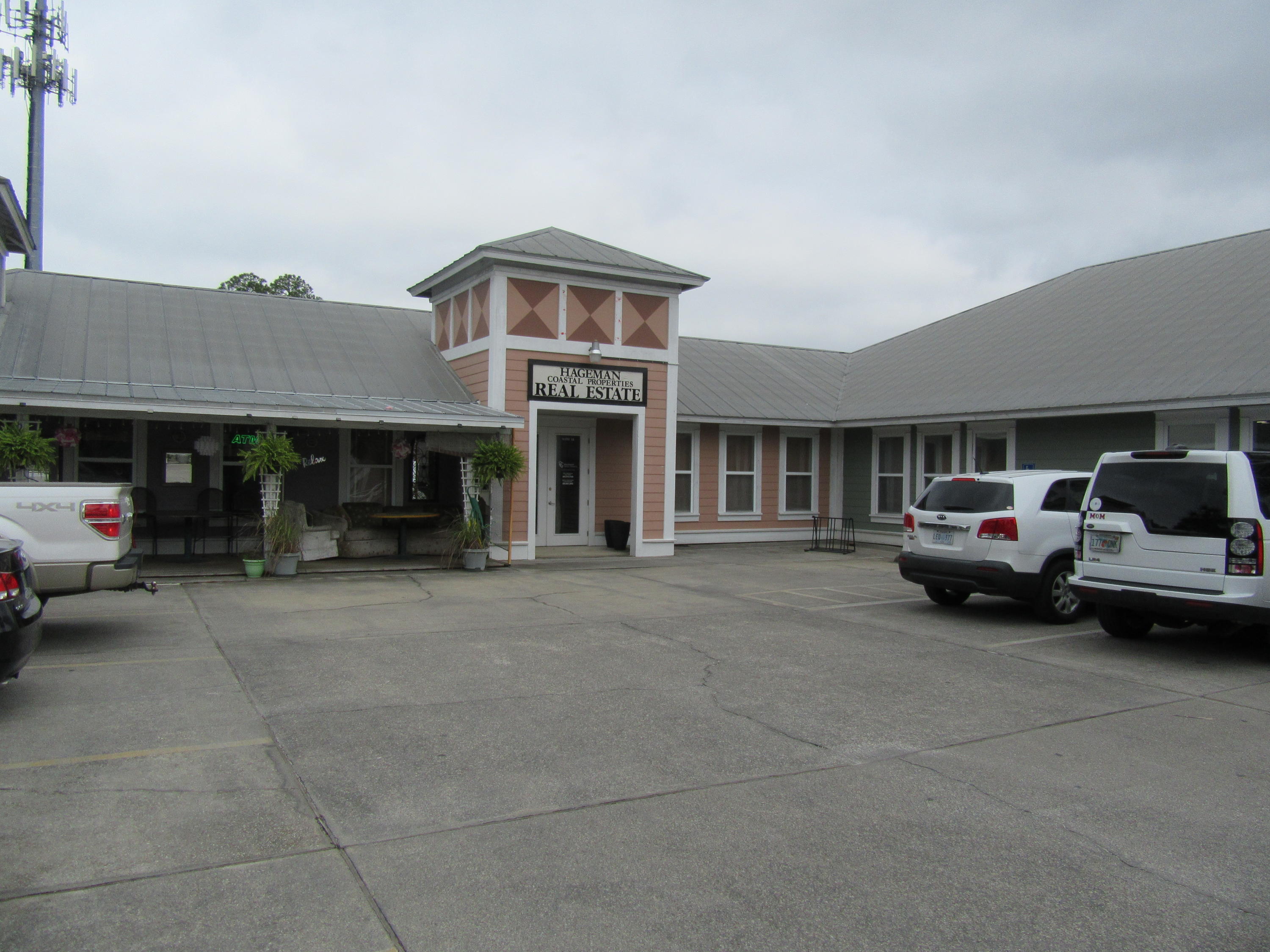 GREAT location! Currently being used as a real estate office, was previously scuba dive business/scuba gear retail. Unit has stained concrete floors with shiplap walls. Has a reception area, 2 full offices with another room in the main office that's utilized as an additional office. Low utilities!