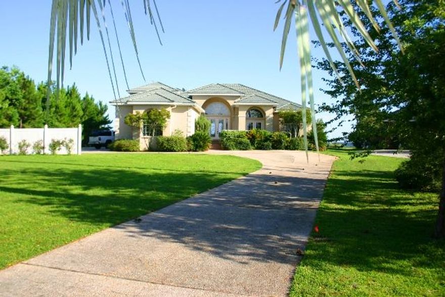 Welcome to this beautiful home located in Dana Pointe! Dana Pointe is a quiet neighborhood with diverse homes, neatly tucked away from the hubbub of Niceville. Best of all, you are right on the bay! This 3 bedroom, 3 bathroom home has it all. It features fantastic views of the bay, a 3 car garage, office or study, sparkling pool, gourmet kitchen, central vacuum, beautiful flooring, and much, much more! Enjoy the water? Then you'll love the lanai with its fantastic view of the bay. It is perfect for entertaining guests or just enjoying a quiet evening watching the sun set. If you have a boat, no problem, as this home comes with a private dock with two lifts (one for jet ski and one for a boat. Homes like this don't come on the market very often, so call to see it today!