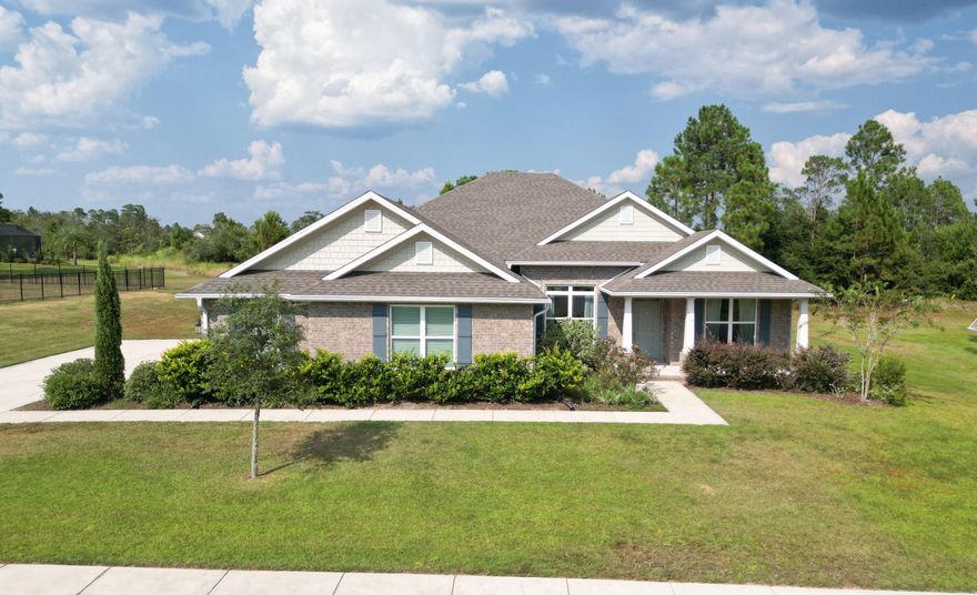 This beautifully designed 3-bedroom, 3-bath home also features a versatile bonus room, formal dining room, and a oversized 3-car garage. Set on a generous 0.79-acre lot backing up to the 8th fairway, you'll enjoy peaceful golf course  and privacy from your large covered patio space perfect for relaxing or entertaining. Inside, the home features granite countertops, engineered vinyl plank flooring in the main living areas, stainless steel kitchen appliances. The open-concept layout flows seamlessly with a thoughtfully designed split floor plan, offering comfort and function throughout. The private owner's retreat provides a luxurious escape with ample space and style. Just 25 minutes from the sugar-white sands of the Emerald Coast, Windswept Estates offers premier community amenities including a community house, swimming pool, tennis courts, basketball court, and a playground. Don't miss your chance to own this stunning home in one of Freeport's most sought-after gated community!