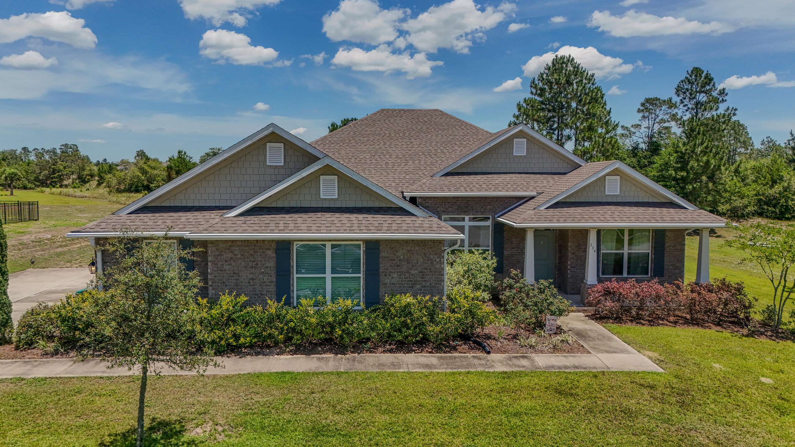 Welcome to 334 Tournament Ln, an exceptional home located in the prestigious, gated golf course community of Windswept Estates. This beautifully designed 3-bedroom, 3-bath home features a versatile flex room, formal dining area, and a spacious 3-car garage. Set on a generous 0.79-acre lot backing up to the 8th fairway, you'll enjoy peaceful golf course and privacy from your large covered outdoor living space perfect for relaxing or entertaining. Inside, the home features granite countertops, engineered vinyl plank flooring in the main living areas, stainless steel kitchen appliances. The open-concept layout flows seamlessly with a thoughtfully designed split floor plan, offering comfort and function throughout. The private owner's retreat provides a luxurious escape with ample space and style. Just 25 minutes from the sugar-white sands of the Emerald Coast, Windswept Estates offers premier community amenities including a community house, swimming pool, tennis courts, basketball court, and a playground. Don't miss your chance to own this stunning home in one of Freeport's most sought-after communities!