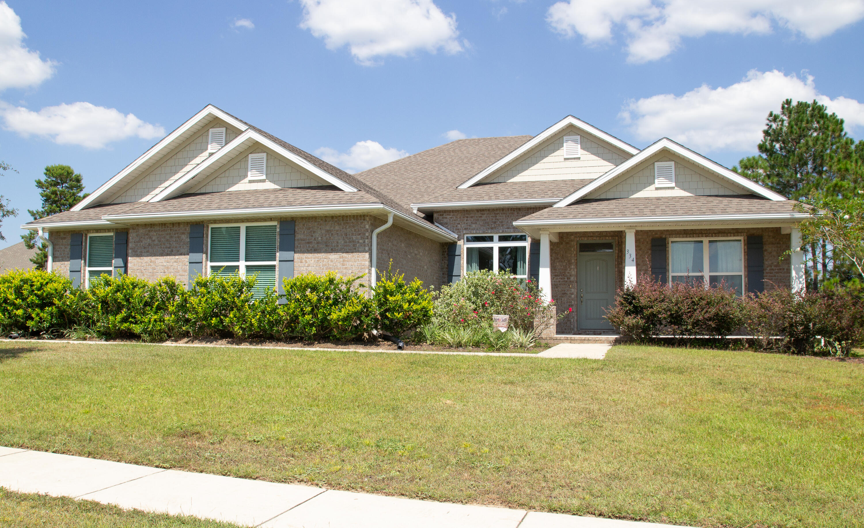 This beautifully designed 3-bedroom, 3-bath home also features a versatile bonus room, formal dining room, and a oversized 3-car garage. Set on a generous 0.79-acre lot backing up to the 8th fairway, you'll enjoy peaceful golf course and privacy from your large covered patio space perfect for relaxing or entertaining. Inside, the home features granite countertops, engineered vinyl plank flooring in the main living areas, stainless steel kitchen appliances. The open-concept layout flows seamlessly with a thoughtfully designed split floor plan, offering comfort and function throughout. The private owner's retreat provides a luxurious escape with ample space and style. Just 25 minutes from the sugar-white sands of the Emerald Coast, Windswept Estates offers premier community amenities including a community house, swimming pool, tennis courts, basketball court, and a playground. Don't miss your chance to own this stunning home in one of Freeport's most sought-after gated community!