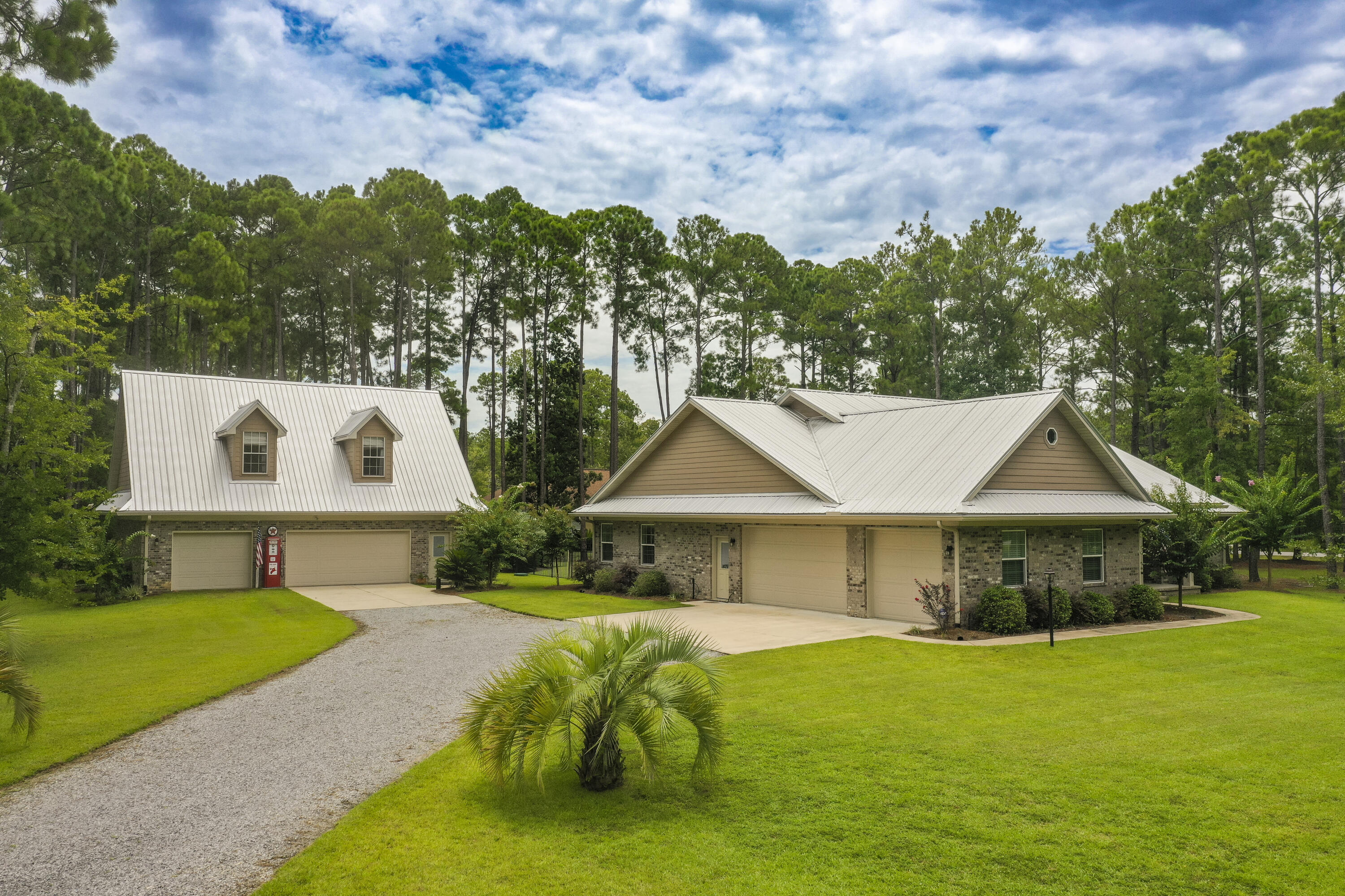Stunning, tranquil estate-style home with pool and an additional 1,066 sq ft full 2-bedroom carriage house nestled on a corner 2-acre fenced site directly across the street from Lagrange Bayou. Bring all your 'toys' as there is garage parking for 6 cars and a covered area for a big RV! Tastefully decorated with warm colors and every detail considered, this custom home features an inviting entryway, engineered bamboo hardwood throughout, a formal dining area, an expansive chef's kitchen with spacious pantry, stainless LG appliances, deep, double sink, and plenty of cabinets, including glass display cabinets, above the long, quartz countertop. There's a sunny, morning room with a wall of windows and a generous great room with cozy wood-burning fireplace.The Master Suite on the main