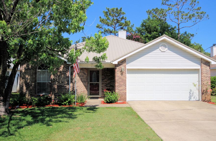 What's sweeter than a home of your own? This move-in ready home features a metal roof, Bruce hardwood floors in the main living spaces, and a great room with vaulted ceilings and wood burning fireplace. There are also great views of outside from the kitchen and French doors leading to the patio. The kitchen, which overlooks the great room, boasts 42 cabinets, granite countertops, an expansive granite breakfast bar, and hardwood floors. The Master Suite features a tray ceiling, walk-in closet, and carpeting. There is an en suite with separate shower, dual vanities, and soaker tub. The two additional bedrooms also have Bruce hardwood floors, and one even includes a walk-in closet! There is a separate main hall bathroom. In the yard, there is a new 6 foot