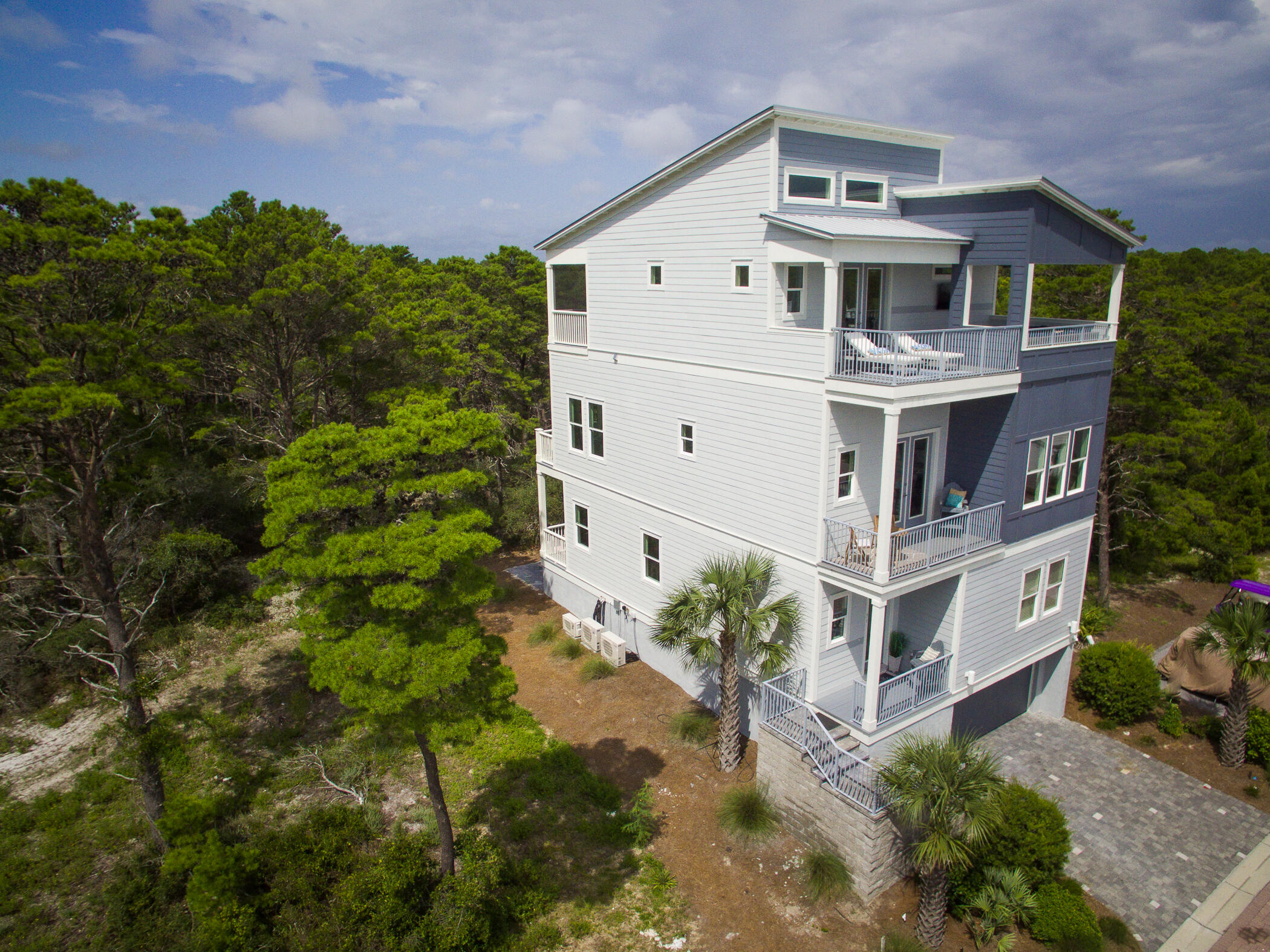 Updated with professional photos.Majestic contemporary beach home viewing the gulf and a short distance to the beach. Separate lock out living area on first floor with 2 bedrooms, living, kitchen, and dining. Laundry on first and third floor. Home has a 850 s.f. garage basement for 3 plus cars. Rear balconies on all 3 levels and a ground entertaining patio. Front balcony on 2nd level and large master balcony on third level. Home is beautifully furnished with all that is needed to move in.