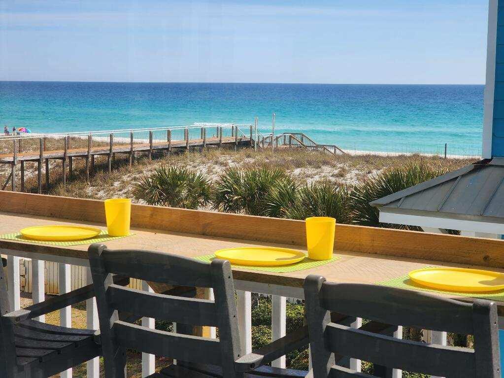 This completely renovated 5 bedroom 3 bath beach home is a coastal paradise with breathtaking views of the Gulf of Mexico. From the moment you step inside, you'll be enveloped by the calming ambiance of this luxurious retreat. The main living area on the top floor features an open-concept design with tile floors, and large windows that frame the spectacular views of the turquoise waters of the Gulf. The living area flows seamlessly into the newly renovated fully equipped kitchen, custom cabinets, granite countertops, and new stainless-steel appliances. Seating space around the counter enough for 6. Plus, an oversized dining area with seating up to an additional 10. Covered outside deck adds even more living/dining area with beautiful Gulf views and comfortable low maintenance furnishings