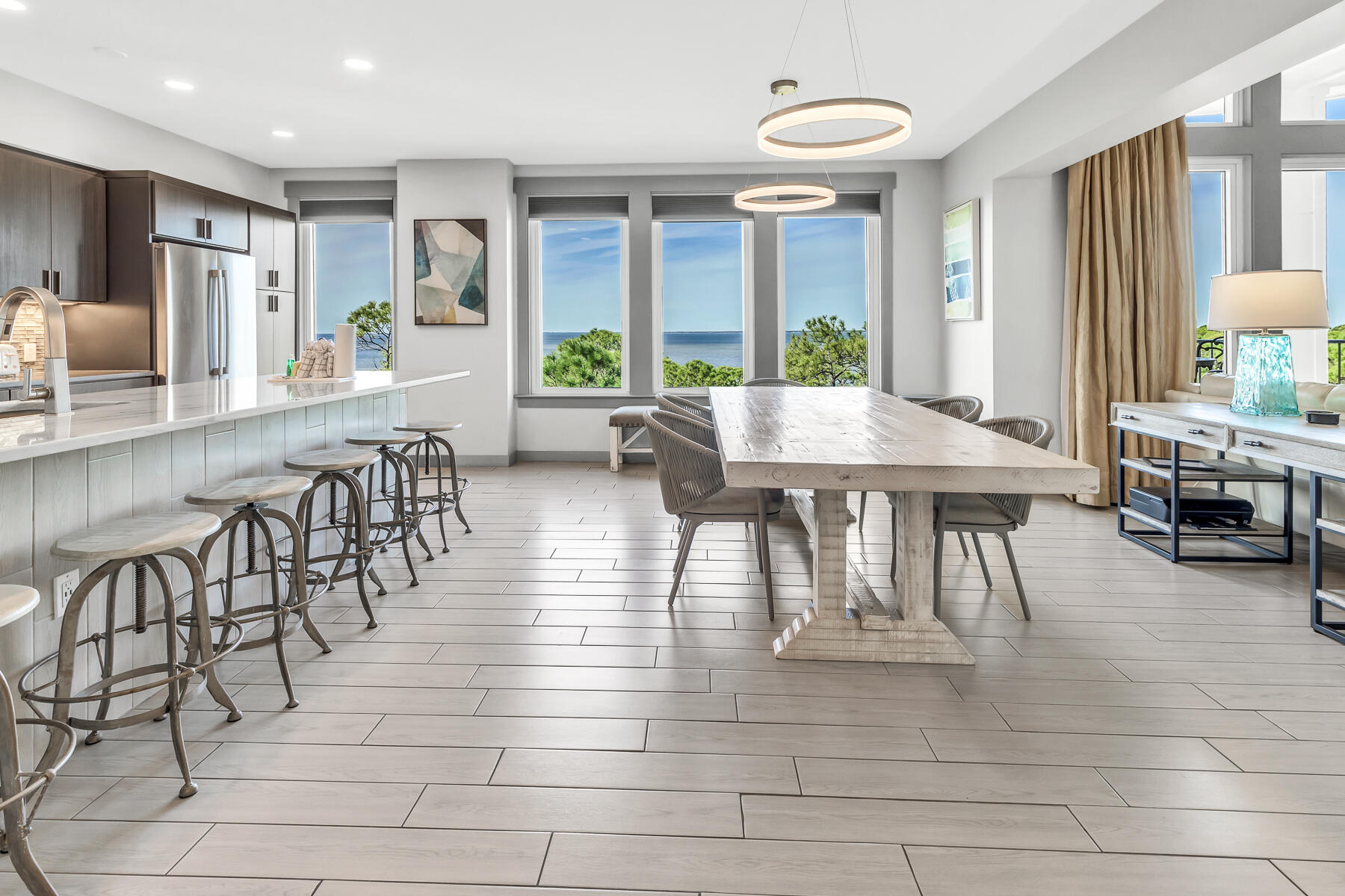 Explore the elevated living experience both indoors and outdoors within this fifth-floor penthouse at Bahia, nestled in the Sandestin(r). This residence captures unparalleled bay views from its dual covered balconies and nearly every room, offering an exceptional perspective. Upon entering, notice the smart lighting panel to illuminate the entire home with just one touch. The chef's kitchen boasts quartz counter tops, tiled backsplash, elevated stainless steel appliances and custom cabinetry. An abundance of natural light fills the main living area with high, raised ceilings. Adjacent to the living area is a den/4th bed. The primary suite affords you the same unparalleled views of the bay, a private balcony and a spa-like bath featuring an oversized walk-in shower and custom walk-in closet.