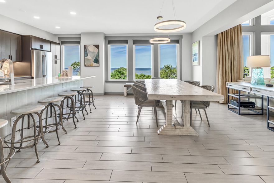Explore the elevated living experience both indoors and outdoors within this fifth-floor penthouse at Bahia, nestled in the Sandestin(r). This residence captures unparalleled bay views from its dual covered balconies and nearly every room, offering an exceptional perspective. Upon entering, notice the smart lighting panel to illuminate the entire home with just one touch. The chef's kitchen boasts quartz counter tops, tiled backsplash, elevated stainless steel appliances and custom cabinetry. An abundance of natural light fills the main living area with high, raised ceilings. Adjacent to the living area is a den/4th bed. The primary suite affords you the same unparalleled views of the bay, a private balcony and a spa-like bath featuring an oversized walk-in shower and custom walk-in closet.