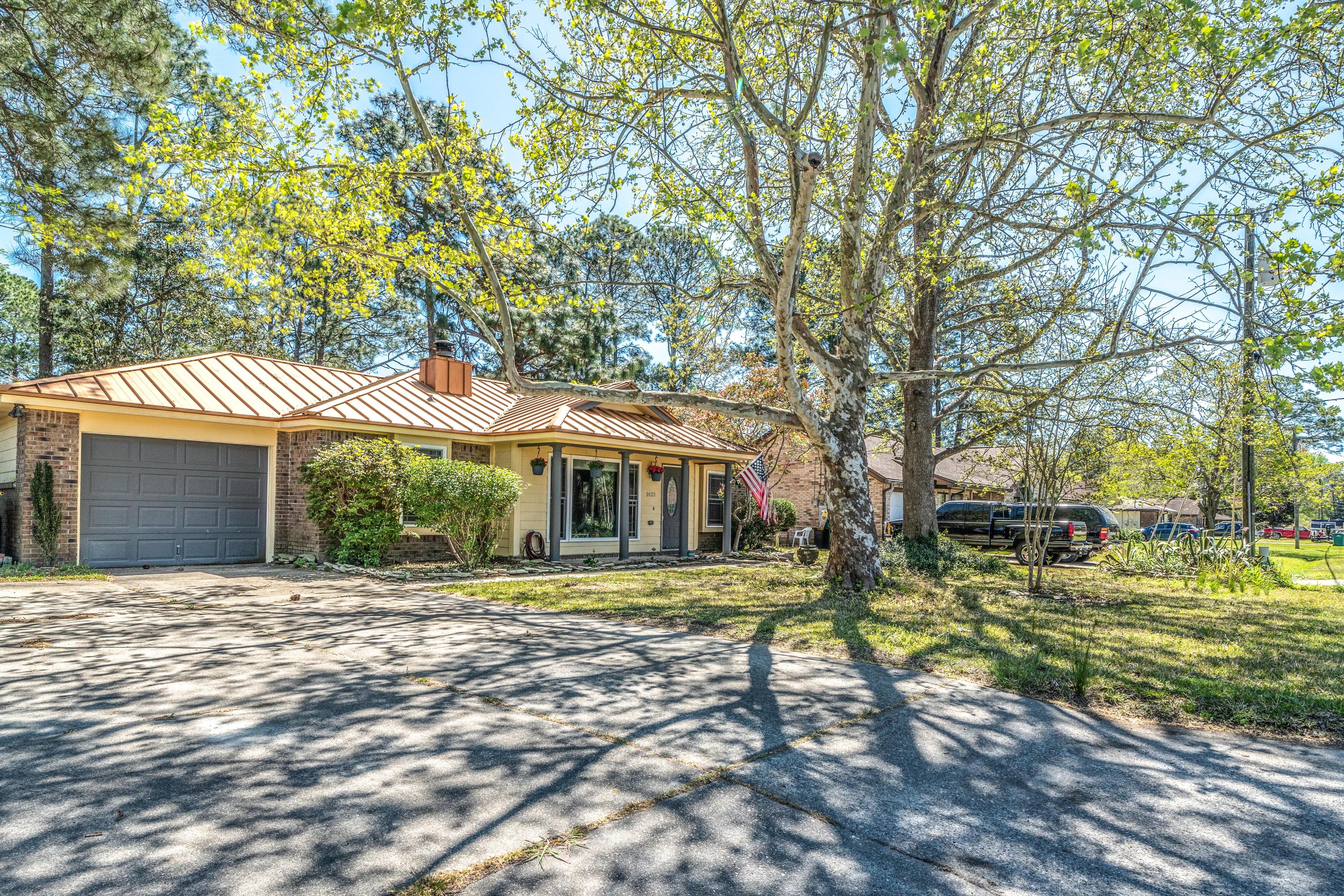 Fall in love with this tres chic Florida cottage from the moment you pull in the driveway. The copper-colored metal roof not only provides low maintenance but also adds a touch of class to this affordable home. If you have been looking for an art studio, gym, man cave or she-shed, then you do not need to look any further! There is an adorable A/C cooled studio building out back as well as the single car garage that is heated and cooled (not included in sq. footage). Windows were replaced prior to the current owners purchase so they are fairly new, which means savings on your energy bills! The kitchen is appointed with a commercial grade six burner range with dual fuel oven, a Bosch dishwaser and brand new Frigidaire Gallery refridgerator. Water heater was just replaced a (con't)