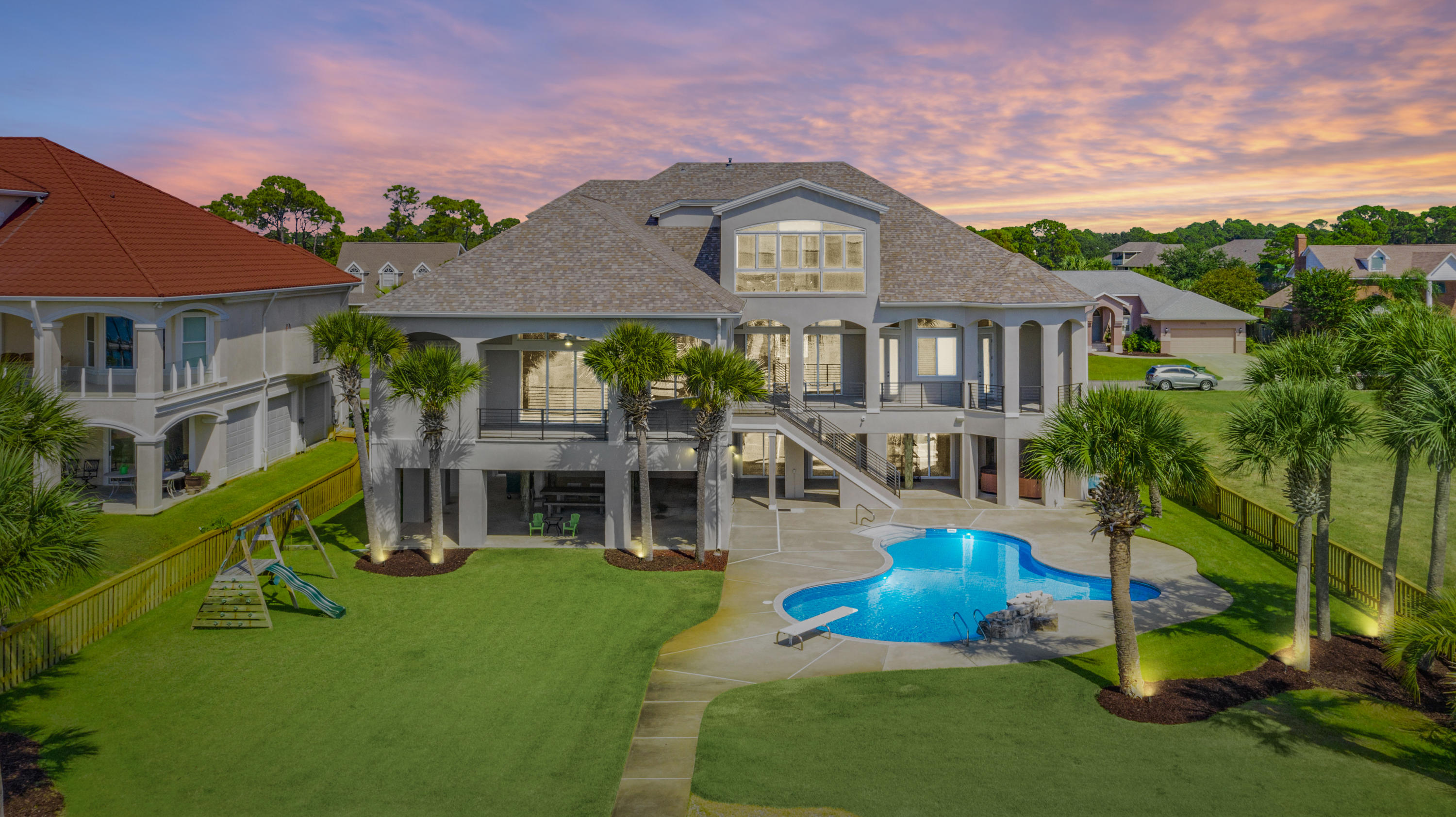 This regal Sound front home resides on the most desirable street in the golf course community of Tiger Point. Upon arrival, you'll note the grand entryway and beautiful landscaping. The open spacious floor plan encourages entertaining with cascading sliding glass doors, opening up to spectacular Sound views onto the covered balcony. You'll also enjoy the oversized dining room, wet bar and pool room while having guests. The kitchen comes fully equipped with two islands, sub-zero fridge, double wall oven, bread warmer and prep sink. The master suite offers sound views, over-sized his & hers walk-in closets and dressing area. Into the master bath with double vanities, soaking tub with a massive shower with 3 shower heads, water closet with a bidet. On the opposite side of the main living flo
