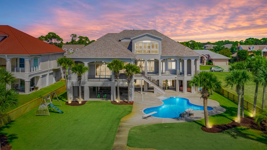 This regal Sound front home resides on the most desirable street in the golf course community of Tiger Point. Upon arrival, you'll note the grand entryway and beautiful landscaping. The open spacious floor plan encourages entertaining with cascading sliding glass doors, opening up to spectacular Sound views onto the covered balcony. You'll also enjoy the oversized dining room, wet bar and pool room while having guests. The kitchen comes fully equipped with two islands, sub-zero fridge, double wall oven, bread warmer and prep sink. The master suite offers sound views, over-sized his & hers walk-in closets and dressing area. Into the master bath with double vanities, soaking tub with a massive shower with 3 shower heads, water closet with a bidet. On the opposite side of the main living flo