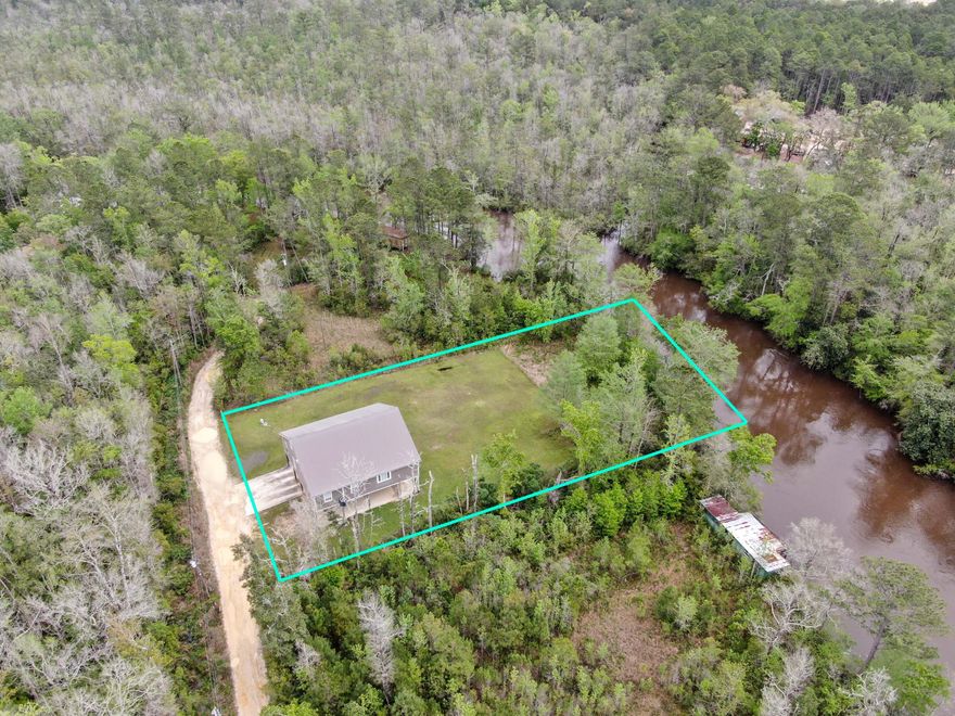 ALAQUA CREEK PRIVATE WATERFRONT RETREAT!  Sellers are ready to sell and are offering $19,000 Buyer's Credit with approved offer! Check out this beautiful 4bd/2ba home on 2 Lots with 120' on the water and almost 3,000SF!! Renovated by the previous owners, so house is essentially move in ready; just bring your boat!!! Here you have room to roam, to store your toys, and all without the hassle of an HOA. Plus this property is close to all the action of some of the world's most beautiful beaches. The house has an open concept kitchen, dining, and living area. The Master Suite even has a creekview. Third Level is an Enormous Room with the view of the Creek; so endless possibilities here to make it your own either as game/media room, etc. Call today and never miss a sunset on the water again!