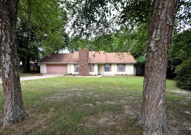 Great location! This lovely 3 bedroom and 2 bathroom home is located south of Crestview and near the bases. Situated on a half-acre lot, with a large backyard that is fenced. The living room has wood laminate flooring and brick fireplace for those cold nights. Spacious kitchen with a pantry and nice dining area with view of the backyard. All appliances are included as well as the refrigerator which was purchased in 2020. New carpet in all bedrooms. Interior living areas and bedrooms have been freshly painted in 2023. HVAC system was installed in 2014. New septic system was installed in 2022. This home has a long deck on the back that goes almost the length of the home, with access to the kitchen and the master bedroom. This deck is great for BBQing and entertaining! The roof is only 9 yr