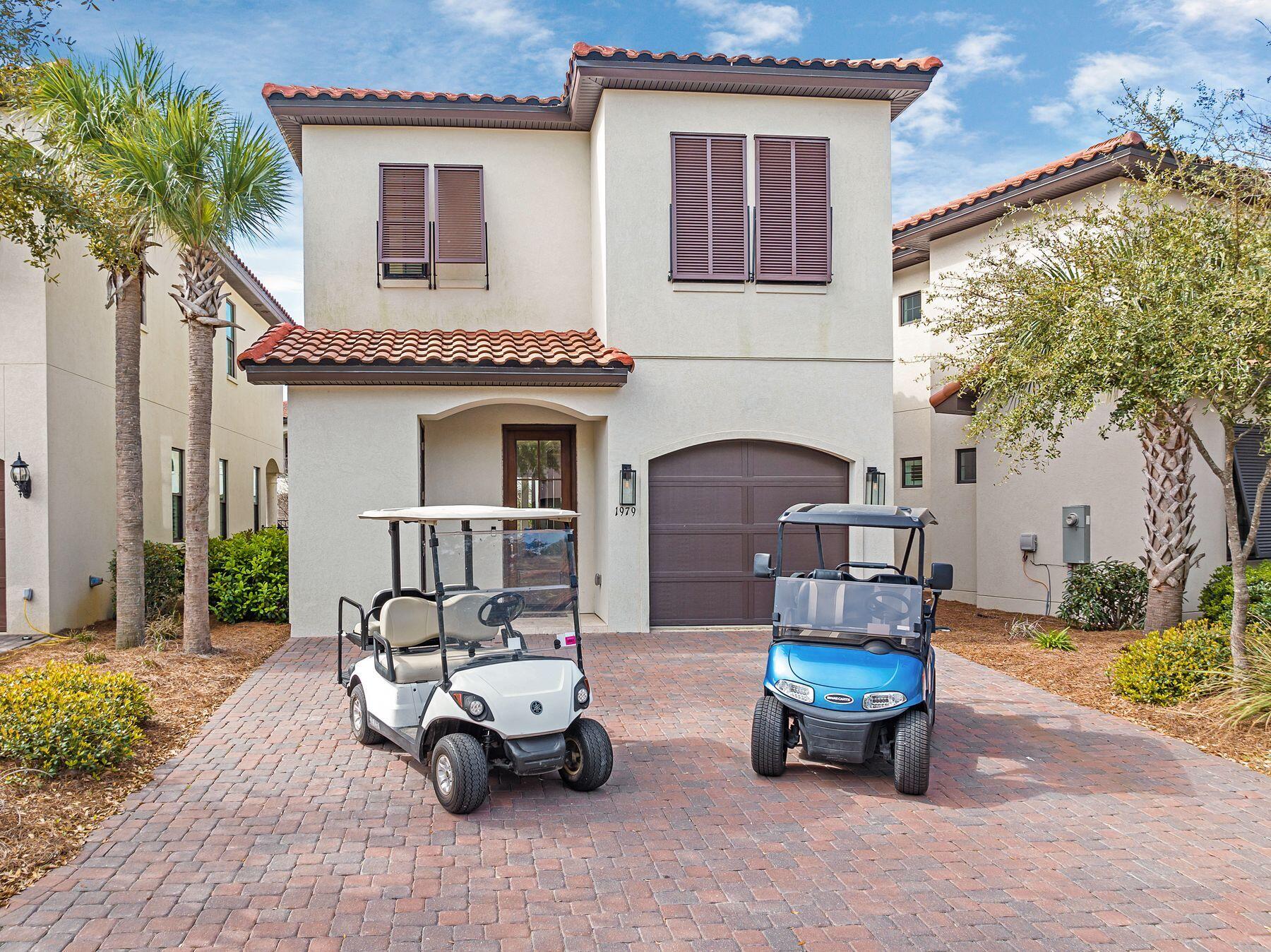 This bright, spacious, nearly new villa has impressive rental history and a well-thought-out floor plan with many extra benefits, including two golf carts. A spacious ground-floor bedroom with a full ensuite bathroom makes this design attractive for families, while the second-floor loft provides an additional sitting area for reading or watching TV. Built in 2022, a covered porch with storage welcomes you into a spacious foyer. The light-filled living room has an inviting ambiance and ample formal dining and entertaining space. The open kitchen has a full array of newer appliances, an island breakfast bar and a pantry providing out-of-sight storage. Head outdoors onto the larger-than-average porch, which includes a summer kitchen complete with grill. The area looks out onto a tranquil green space with a trickling stream. The first-floor guest bedroom includes a king-sized bed, his-and-hers closets and a beautiful private bathroom with a fully tiled curved shower. Head upstairs to the loft area, furnished with a TV and a pull-out sofa for additional guests. Served by a mini kitchenette complete with beverage refrigerator, it makes a useful second living space for families to hang out. Three additional bedrooms all have TVs and ensuite facilities. The king-sized master suite includes a bathroom that is exceptionally well appointed. It has a twin vanity and a huge tiled shower with a deep soaking tub. There's more owner's storage and a laundry closet on this floor. An integrated one-car garage provides parking and storage for the four-seater golf carts, which are included in the sale of this fully furnished home. Located within the 2,400-acre Sandestin Golf and Beach Resort, this Villa Lago home has access to a beautiful community pool and an abundance of amenities. As well as access to seven miles of pristine beaches, the resort offers four championship golf courses, 15 world-class tennis courts, a 226-slip marina, a fitness center, spa, boutique shopping and outstanding international restaurants.