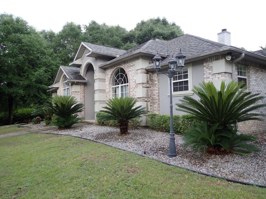 A stunning Fannie Mae Homepath REO! Built in 1999, this stylish home has 3 bedrooms 2 and 1/2 baths and is right at 2458 square feet. Located on 1.06 acres, this home has all brick exterior with stucco high lights, side entry 2 car garage and bonus single car garage for lawn equipment, carts, or of course, that 3rd car! . A corner lot home with privacy fenced back yard, large gazebo, and many varieties of palm trees throughout the property. Inside, this home has new wall to wall carpet, tiled floors in wet areas, large sunroom/bonus room and split bedroom design. Home has new paint throughout, new appliances, and should qualify to all types of financing. With a circle drive for additional character and appeal, this is definitely one property you will not want to miss.