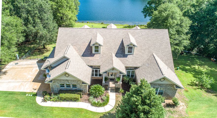 Kick Out Clause in place. CUSTOM Lakefront home on nearly 4 acres! Centrally located, custom brick work, 3 bedroom, 2.5 bathroom, 3 car side entry garage on 1000 feet of lakefront property. This special home features 12'ceilings in the foyer, formal living room, and study. The home offers an open family room has a 12' double tray ceiling with crown molding, gas fireplace, custom cabinets in kitchen, and built in entertainment center, walk-in pantry, surround sound in LR and MB, large closets, crown molding, Granite counter tops, all stainless appliances, travertine tile, whirlpool tub and tile shower in MB, central vac, new carpet, new HVAC, 2x6 exterior walls with R-19, 20 KW generator, Low E windows and doors, irrigation system, security system, 20'x30' gunite pool with 8 person hot tub