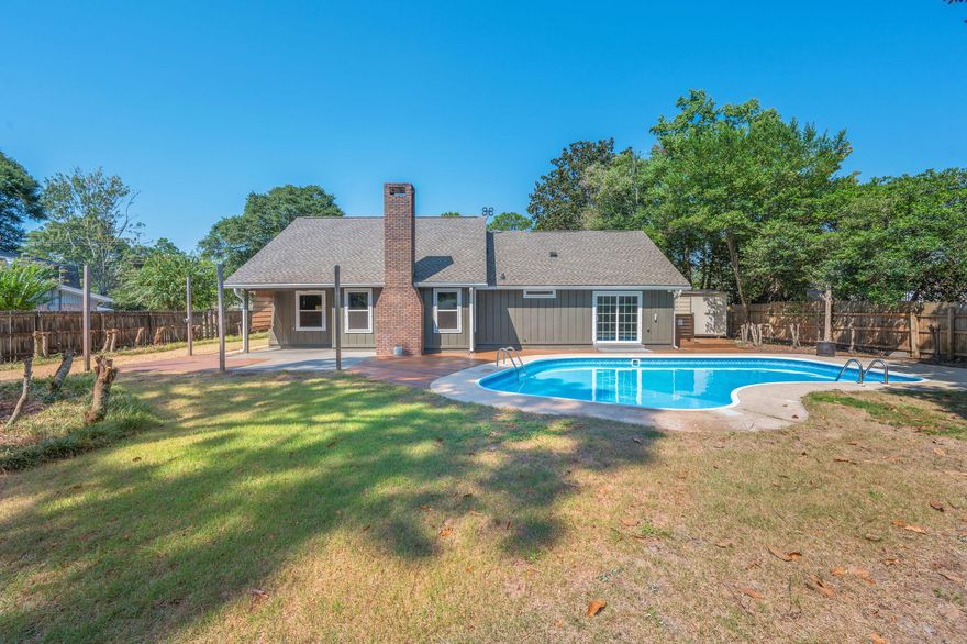 This beautifully renovated 4BR/2BA brick home combines timeless charm with modern updates. The two-story layout features vaulted ceilings, an inviting entryway, and a cozy brick wood-burning fireplace. Luxury vinyl plank flooring flows through the main living areas, while updated lighting and window coverings add a fresh, polished look. The formal dining room connects to a fully renovated kitchen with upgraded cabinetry, stone countertops, subway tile backsplash, farmhouse sink, stainless steel appliances, recessed lighting, and designer trim. The primary suite offers pool views and a sliding glass door leading to the backyard. The en-suite bath includes a dual-sink vanity, walk-in tile shower with rain head, glass enclosure, and a spacious custom closet. Guest bedrooms feature plush carpet, natural light, and built-in shelving, with a refreshed guest bath showcasing a subway tile tub/shower combo and stone vanity. A versatile upstairs bonus room provides additional living space. Outdoors, enjoy your own private retreat with a sparkling pool, extended pool deck, covered patio, storage shed, mature trees, and a fully fenced oversized yard. An oversized two-car garage with washer/dryer hookups completes the home. Move-in ready and perfect for entertainingthis one has it all!