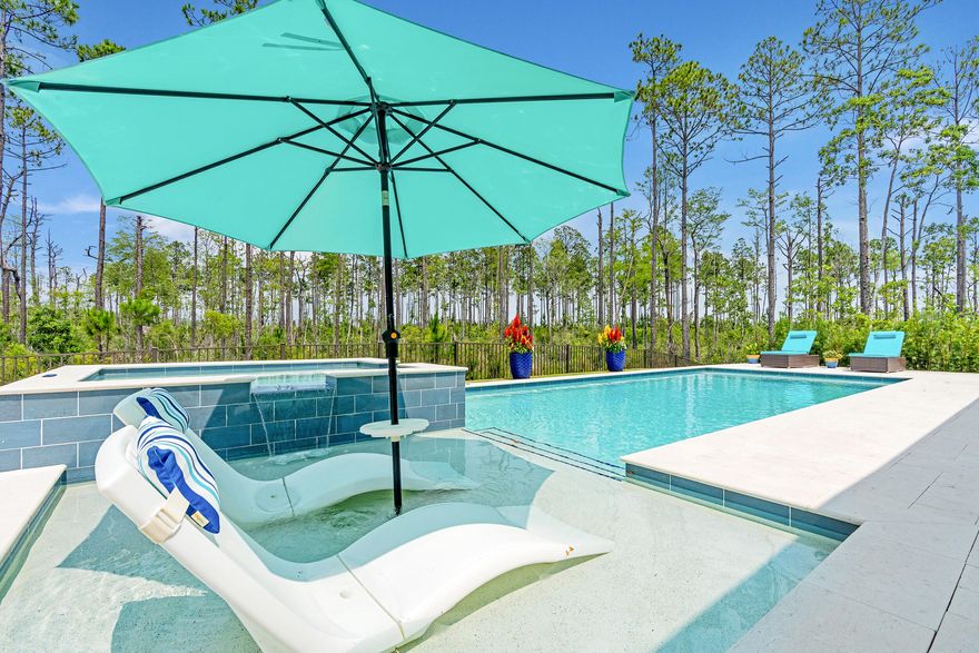 One of only five homesites in the community with rare privacy with serene wooded surroundings on two sides.  Home has one of the largest pools and hot tubs in neighborhood.  These motivated sellers are ready to move soon as they downsize into a new home in NatureWalk at Origins!Welcome to the Venice floor plan--an exceptional 5-bedroom, 4.5-bath home offering luxury, flexibility, and privacy, all ready for immediate move-in. Thoughtfully designed for multi-generational living, this home features two bedrooms on the main floor, including a spacious primary suite. The two-story living room is an architectural showstopper with a striking linear fireplace framed by floor-to-ceiling tile, creating a dramatic focal point that flows seamlessly into the outdoors. Step through the 5-panel sliding glass doors to your massive covered porch, equipped with motorized screens and overlooking a beautifully paved patio. It all opens up to one of the largest and most private pool and spa retreats in the neighborhood,backed by serene woods on two sides for unmatched privacy. Inside, the gourmet kitchen is a chef's dream, outfitted with high-end GE Caf?? appliances, including a 60" gas cooktop and an oversized refrigerator and freezer. Just off the kitchen, you'll find a generous laundry room and a beverage hub featuring multiple wine fridges and an ice machine- perfect for entertaining, whether you prefer red or white. The main-floor primary suite boasts a spa-like bath with a soaking tub, oversized shower with multiple heads, and a customized walk-in closet with built-ins. An additional en suite bedroom and a bright, inviting office complete the first floor.

Upstairs, discover three more bedrooms (one en suite) and an open loft-style living space perfect for relaxing or hosting guests. Lovingly maintained and loaded with designer upgrades- including custom lighting, built-ins, and plantation shutters- this home is like new, but better. Located in NatureWalk at Watersound Origins, enjoy easy access to top-rated schools, Publix, local dining, and the beautiful beaches of 30A. Don't miss your chance to own this one-of-a-kind home in one of the most sought-after neighborhoods on the Emerald Coast. Schedule your private showing today!