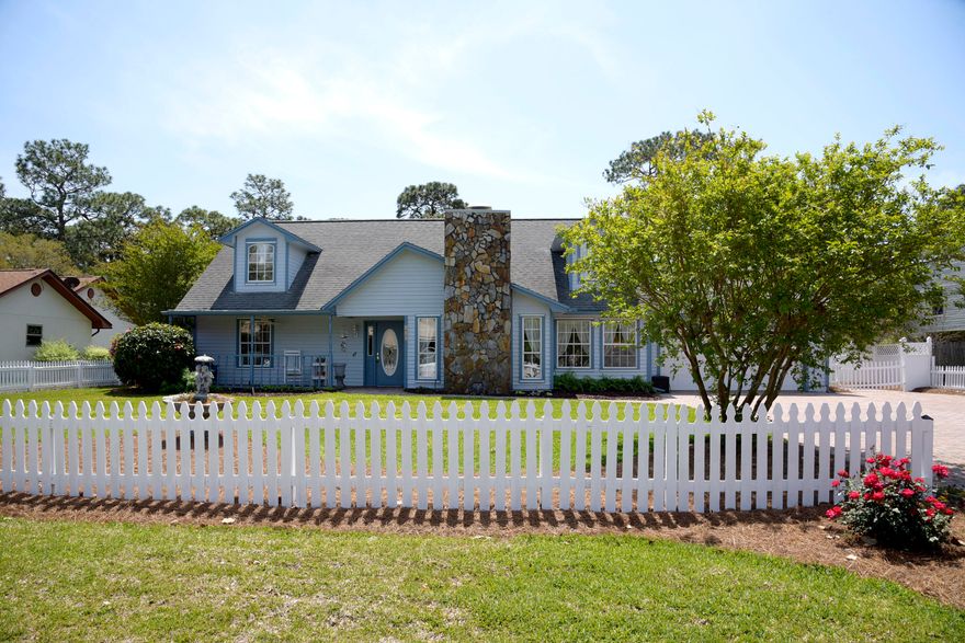 A wonderful family home located in a quiet subdivision which has been updated thoughtfully and beautifully throughout ownership is waiting for you.   Spacious and bright living areas bring the outdoors in through a soaring window of walls.  Lovely landscaping with gardens, blooming flowers year round, grand towering trees, built in grill and patios framed by a picket fence.  Jackson Guard/White Point recreation area borders the lot to the rear where you'll find a wide pathway to a bay front sandy beach.  A permit from JG for a nominal fee allows access.  A neighborhood bay front park is available for enjoyment by all owners.  A non-mandatory association fee of $100 annually to Raintree Est owners association.