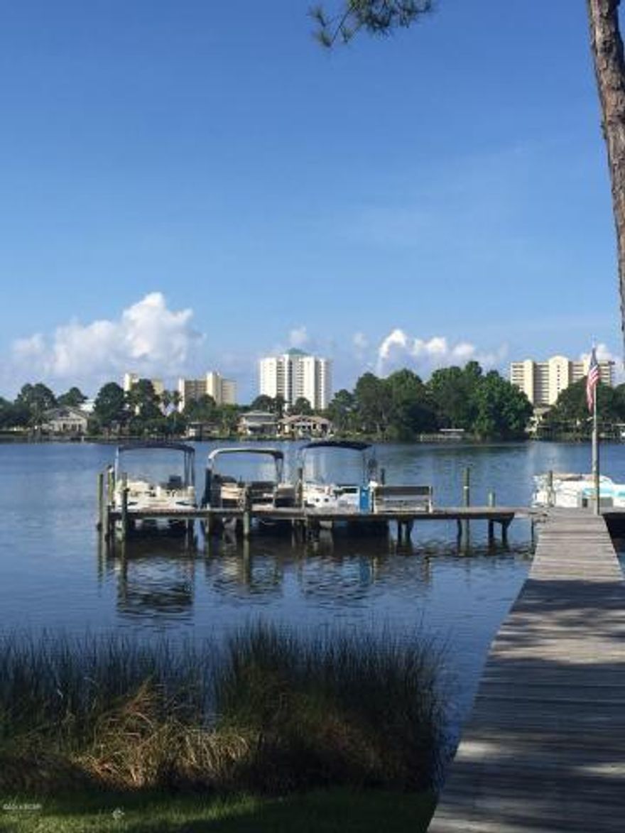 This is such a sweet waterfront community on Grand Lagoon. This unit has been recently remodeled with new flooring, painting, updated kitchen with granite countertops and stainless steel fridge and stove. Bring your boat, fishing rods and swimsuit. This complex is an Anglers dream. The complex has a community boat dock on the lagoon which has Gulf access, a picnic area, pool, tennis, overflow parking area for your boat trailer. After a day of fishing relax on your balcony or poolside. This unit has washer and dryer hookups or you can use the onsite laundry facility. Don't wait too long! On the water for under $100,000! Great opportunity!