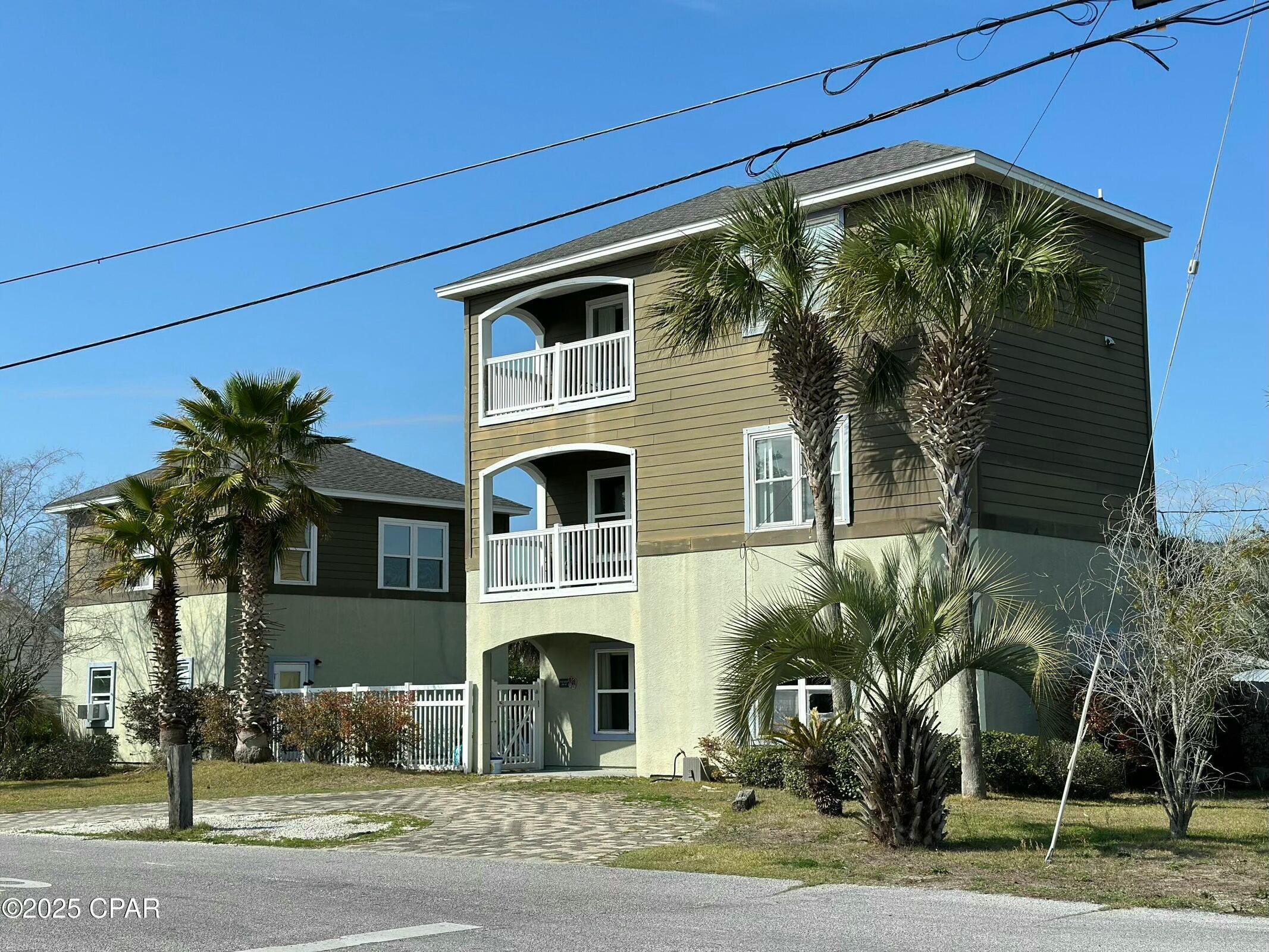 Drastic Price Reduction - Motivated Seller! This charming 3BR/3.5BA beach home with a guest house and private pool is ideally located in the heart of PCB, just a short walk to the Gulf. Blending comfort and coastal style, it's perfect for relaxing or entertaining. The main floor features an open kitchen/dining area, half bath, storage, and a bright living room with 9-ft ceilings, crown molding, and patio doors leading to a private kidney-shaped pool. Upstairs are two bedrooms with en-suites and balconies. The top floor offers a spacious loft, master suite, and private balcony with skyline views. The 1BR/1BA carriage house is great for guests or rental income. Ideal as a primary home, vacation retreat, or investment!