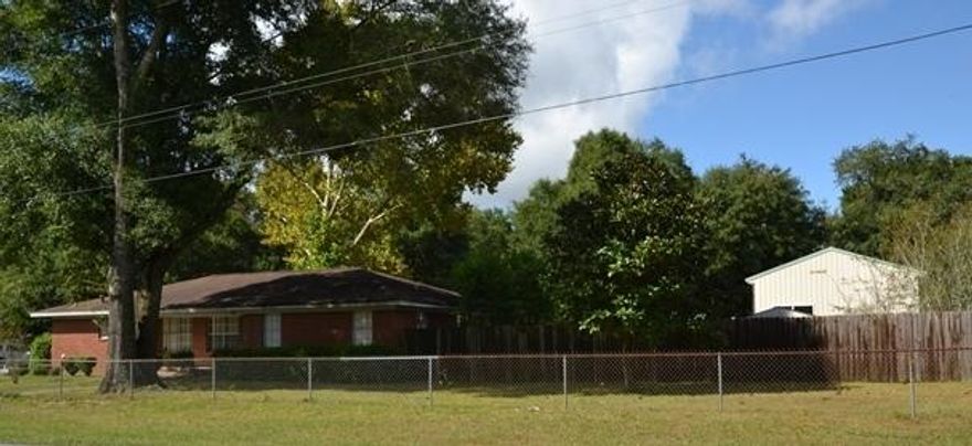 Great LOCATION for a Business with visibility to Hwy 85 South at an AFFORDABLE Price! WORK FROM HOME! 1,700+ sq.ft. house/office with 4 rooms, 2 bathrooms, open concept floor plan, fireplace and screened porch. 1,700+ sq.ft. 3 Bay Garage with insulated 30 x 24 office/living space. Potential to make the Garage RENTAL INCOME! Conveniently located off of Hwy 85 South and Downtown Crestview. Fully fenced with chain lin across the front and 8' privacy fence back yard. Freshly painted and ready for your new flooring. Schedule your viewing today!