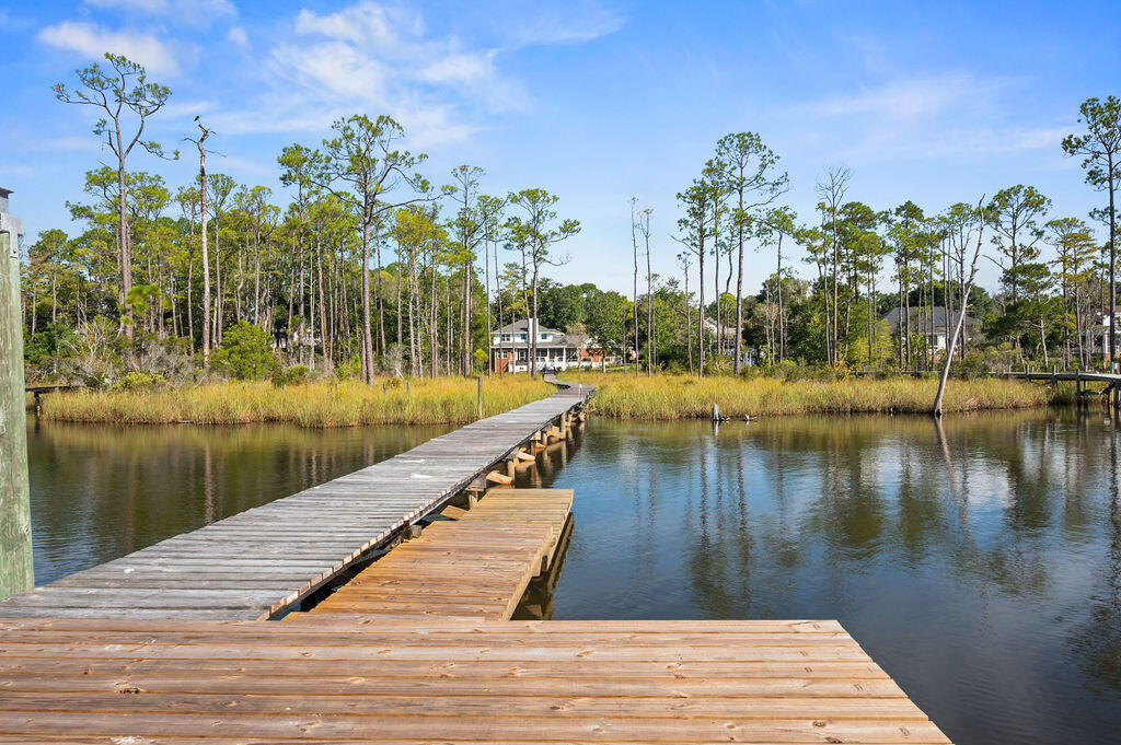 Ask your agent about special VA financing for qualified veterans with a 2.75% fixed rate opportunity! Experience This rare oportunity and breathtaking bayou views with ultimate privacy on this over 1-acre estate with direct water access. Enjoy a private boat dock with slip and lift--perfect for boating, fishing, and watching stunning sunsets. The home's main level offers panoramic water views from the kitchen, great room, and owners' suite with sitting area. A guest suite upstairs also overlooks the bayou. The outdoor living space has been beautifully updated with expanded decking, new railings, a large screened porch, hot tub with deck surround, and enclosed under-deck storage. Fully remodeled master bathroom (2024)
Newer stainless steel appliances in kitchen.
Designer paint, updated lighting & ceiling fans throughout.
Remodeled laundry room with washer, dryer, cabinets & shelving.
Two custom master closets (2024/25)
Remodeled bonus/activity room with painted cabinetry
Impact-rated, UV-protected windows & doors by Folkers (2022)
Additional attic insulation for year-round comfort
Popcorn ceilings removed
Recent Investments Include:
New landscaping & tree removal
New sea wall
New screened porch (2022) & hot tub
Dining & kitchen flooring updates
Whole-home Reme Halo LED air purifier (2021)
Roof (2016), Water Heater (2018), HVAC systems (2013, both with UV light)
This is a must see home today!
