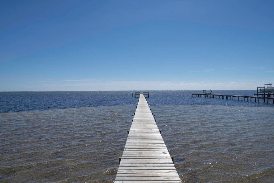 Imagine waking up to breathtaking views in Smugglers Cove, an exclusive waterfront community along the pristine Santa Rosa Sound. This prime corner lot is thoughtfully positioned to provide both peaceful seclusion and effortless access to the water, backing up to a tranquil pond--a perfect retreat for relaxation. Whether you're launching your boat from the private community ramp, enjoying a quiet afternoon of fishing from the dock, or cruising in the Sound at sunset, this location offers unparalleled coastal living. Indulge in resort-style amenities, including a pool and tennis courts, all while benefiting from an exceptionally low HOA. Best of all, this property sits in an X flood zone, meaning no flood insurance is required, giving you significant long-term savings and peace of mind. Whether you're dreaming of building a custom coastal retreat or securing a prime investment in a high-demand waterfront community, this property delivers the ideal blend of lifestyle, location, and lasting value. Opportunities like this are rareschedule your visit today and claim your piece of paradise!

