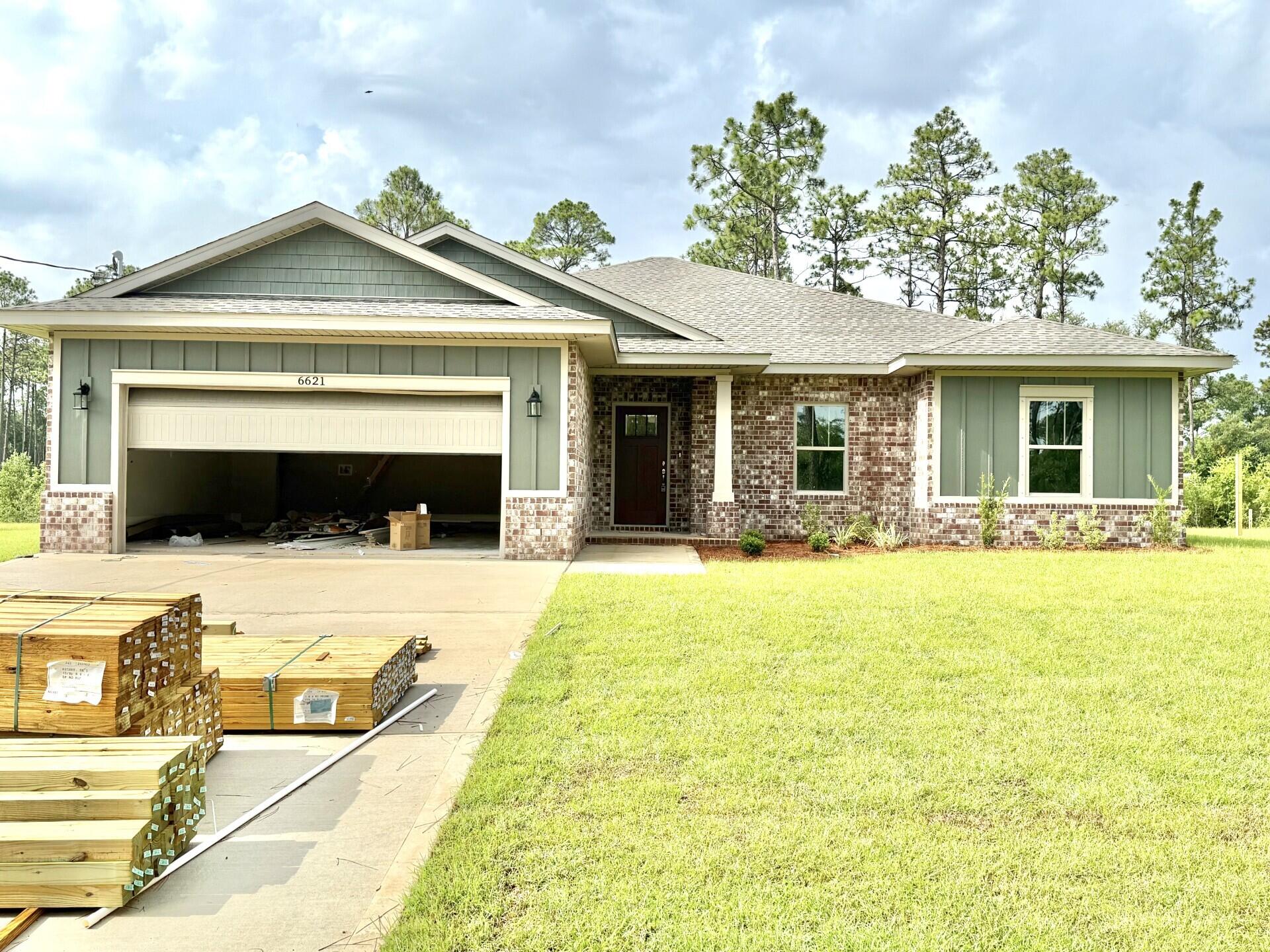 No Wetlands & Located in an X flood zone, this exceptional new home features many upgrades throughout. Clad with the timeless durability of brick, cement fiber board accents, and an architectural shingled roof. Interior offers luxury vinyl plank in the common areas, visually pleasing neutral tile in the baths and laundry room, and carpet in the bedrooms. Custom paint color is accented with a wide baseboard, beautiful crown molding, and spectacular tray ceiling accents in the master bedroom, dining and entry area. Transom windows over the hall entryways provide a high-end custom touch. Stainless steel appliances including refrigerator, stunning shaker style cabinets, and granite throughout finish the home exquisitely.