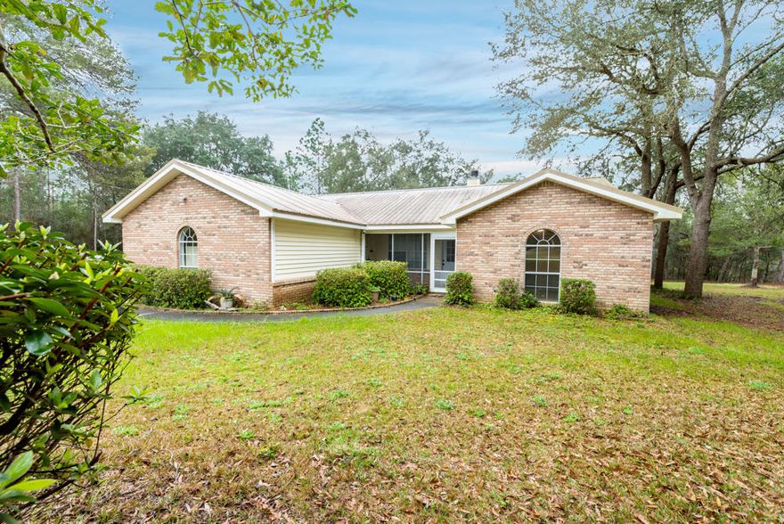 3.45 ACRES*Seller is MOTIVATED*Move in Ready! 3/2 with a Bonus Room! Open floor plan with a large separate master suite. Master bath has a dual vanity, updated lighting and a large walk in closet. Freshly updated kitchen with gorgeous granite, custom cabinetry, updated lighting and appliances. Living room with its vaulted ceiling and wood burning fireplace add additional character. Garage was enclosed during the original build, seller added Heat/AC for an additional 285 square feet of living space!!! Man Cave Anyone? This home has a metal roof and on a private well. Beautiful country setting near Yellow River Wildlife Management Area. Only 15 minutes from Crestview with easy access to I-10 Yard buildings convey ''as is'' All reasonable offers considered.