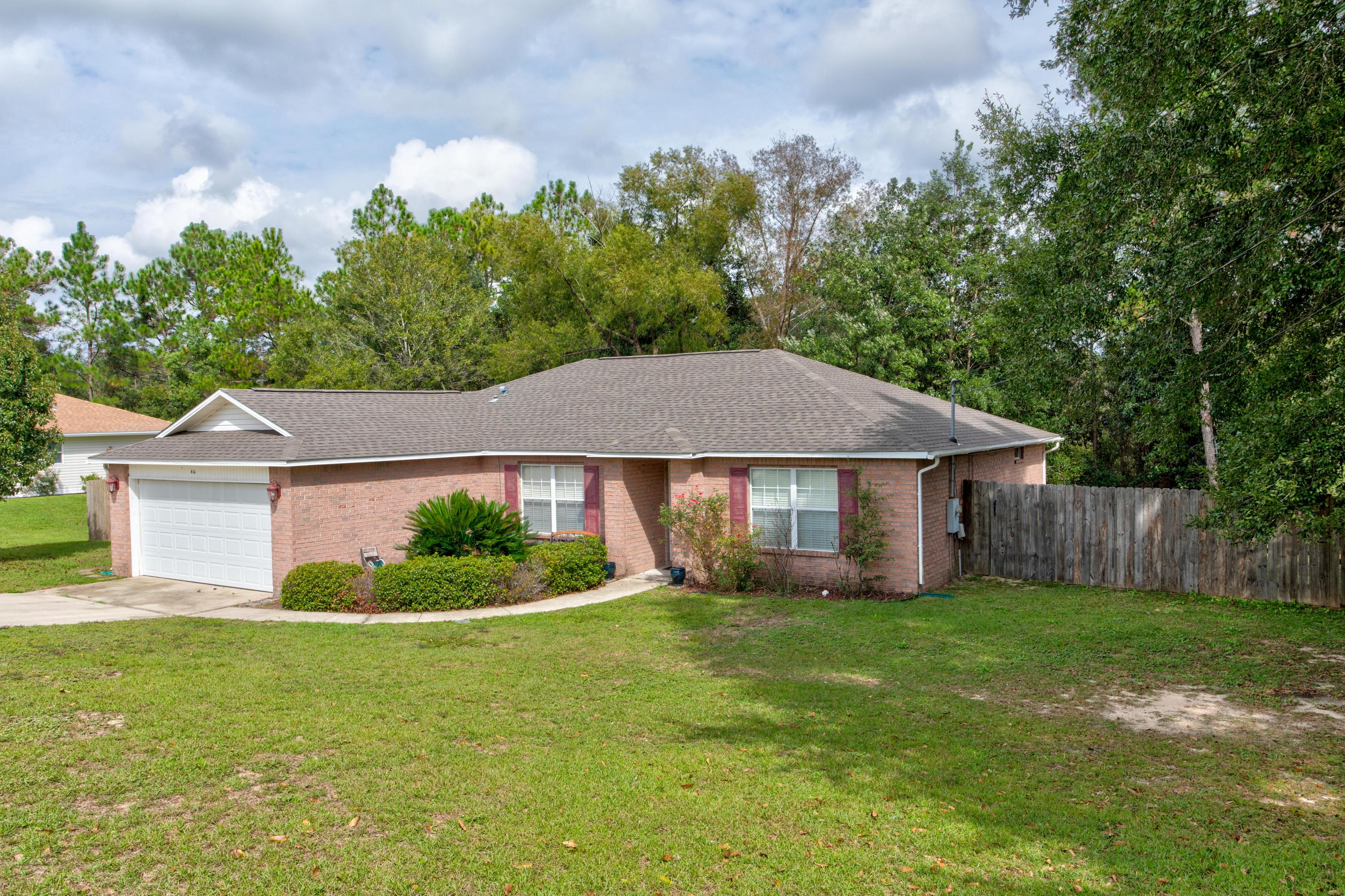 This 4BR/2BA home is convenient to town, 7th SFG, & Eglin AFB. It is just south of I-10 off of PJ Adams. The split floor plan is enhanced with the laminate flooring throughout the entire home, NO CARPET here! The master suite boasts a large master bath complete with a walk-in closet. In the kitchen, you will find a center island, pantry, and ample cabinet space. Outside is fully fenced and features a deck that divides 2 level side yards that are great for entertaining and play; storage shed conveys. Yard backs to greenbelt for privacy. New roof in April of 2019!!