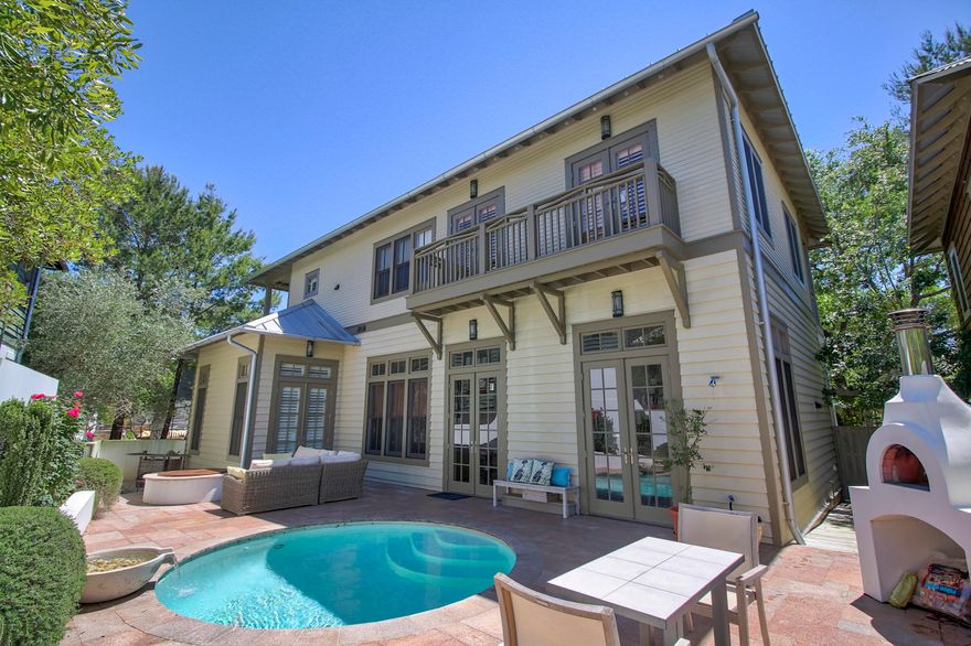 THIS IS THE ULTIMATE BEACH RETREAT! Perfect for entertaining this home was designed with an open floor plan that flows out to the courtyard offering a heated pool, summer kitchen, fire pit, all brick pizza oven and a zen garden. All so you can enjoy outdoor living at it's finest.The first floor of the home includes the living, dining, kitchen and the master bedroom. The second floor boasts three guest bedrooms each with their own private bath. There is a gathering area and media room for the family to enjoy as well. Wrap around porches on both the first and second floor will invite you to relax and enjoy the tranquility of this wonderful boardwalk location.The double car garage and carriage house adds even more to this wonderful home. You need to come and see this home for yourself.