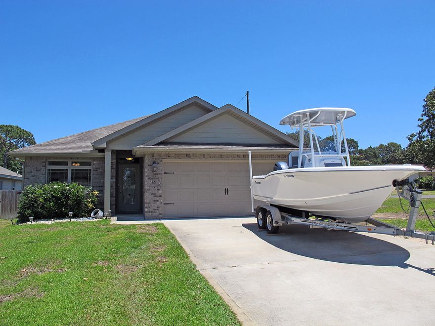 What a charmer! Nearly new 3-bedroom 2-bath home is perfect for first-time homebuyers or downsizing. Lives larger than its 1462 square feet and features lots of bells and whistles! A beautiful glass front door greets you. The spacious living area has raised ceilings and opens to both kitchen and dining areas. A split floor plan separates the master from the other two bedrooms. Everything today's buyer wants!The modern kitchen offers roomy granite counters, sunny white cabinetry, and lots of storage including a pantry. The home has been freshly painted in modern gray, the wood-look laminate flooring in the living room adds warmth, and there is 20'' tile in the kitchen/dining areas.Keep reading!