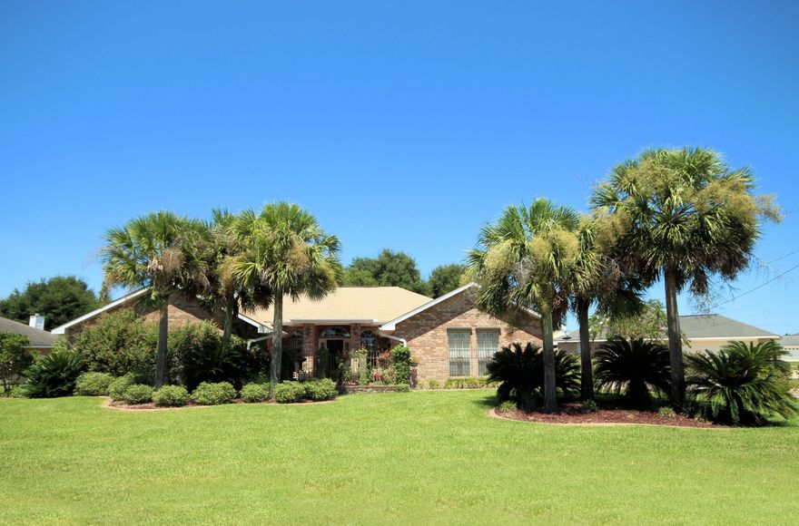 This beautiful property offers custom landscaping which gives this a home a welcoming, rich curb appeal. The brick paved walk-way leads through a bricked, wrought iron gated courtyard. On either side of the Entry is the formal dining room on your right and formal living room area on your left. Beautiful hickory floors adorn the spacious family room. The Large kitchen features stainless appliances, granite counter-tops, a custom tile mosaic back splash, central island, and lots of cabinetry. French doors open from the kitchen into the separately heated and cooled Florida room overlooking the screened-in pool.The master bath boasts his-and-hers cultured marble vanities, custom tile work, and a rendering ocean mural painting surrounding the garden tub.