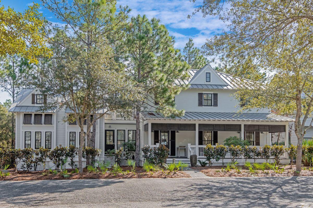 This remarkable custom-built home in WaterColor was designed with family gatherings and happy celebrations in mind. With large picture windows and shady porches, this home epitomizes Southern living at its best. It offers numerous rooms for cozy chats and get-togethers and includes two staircases in the expansive floor plan. Fully furnished, this family-friendly residence is ready to accommodate all your summer guests. The light, bright first floor has low maintenance tile plank flooring and a flow of intimate living spaces including a swoon-worthy kitchen. White drawer-lined cabinets house a plethora of gadgets and appliances. A half-height peninsula and a breakfast bar on either side maintain the open space for conversation in both directions.