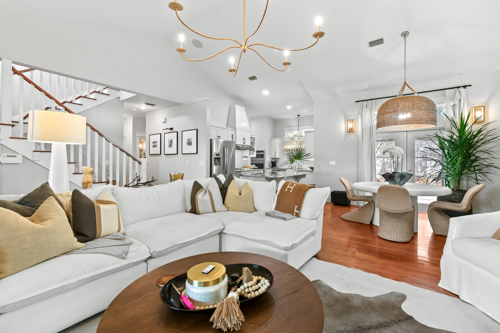 This beach house resides within the exclusive confines of Summer Ridge, a tranquil gated community . With a firm commitment to maintaining a peaceful atmosphere, this rental-restricted neighborhood offers a serene escape from the bustle of everyday life. The allure of this custom-built residence lies not only in its idyllic location, but also in its superb indoor and outdoor entertainment spaces. Step outside into the expansive fenced backyard, complete with a cozy fire pit perfect for those cool autumn nights. A delightful screened porch with a spa tub seamlessly connects to the magnificent great room, characterized by its soaring vaulted ceilings and a captivating stone fireplace.