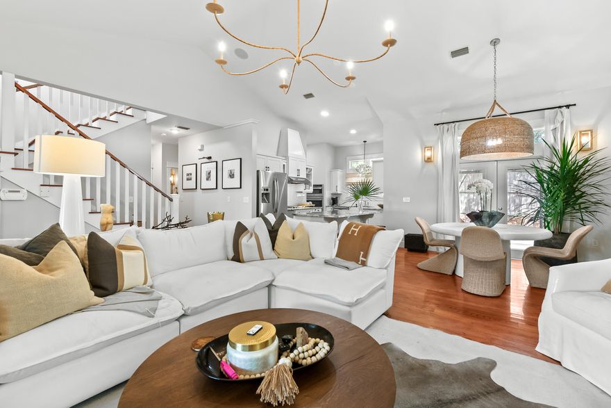 This  beach house resides within the exclusive confines of Summer Ridge, a tranquil gated community . With a firm commitment to maintaining a peaceful atmosphere, this rental-restricted neighborhood offers a serene escape from the bustle of everyday life. The allure of this custom-built residence lies not only in its idyllic location, but also in its superb indoor and outdoor entertainment spaces. Step outside into the expansive fenced backyard, complete with a cozy fire pit perfect for those cool autumn nights. A delightful screened porch with a spa tub seamlessly connects to the magnificent great room, characterized by its soaring vaulted ceilings and a captivating stone fireplace.